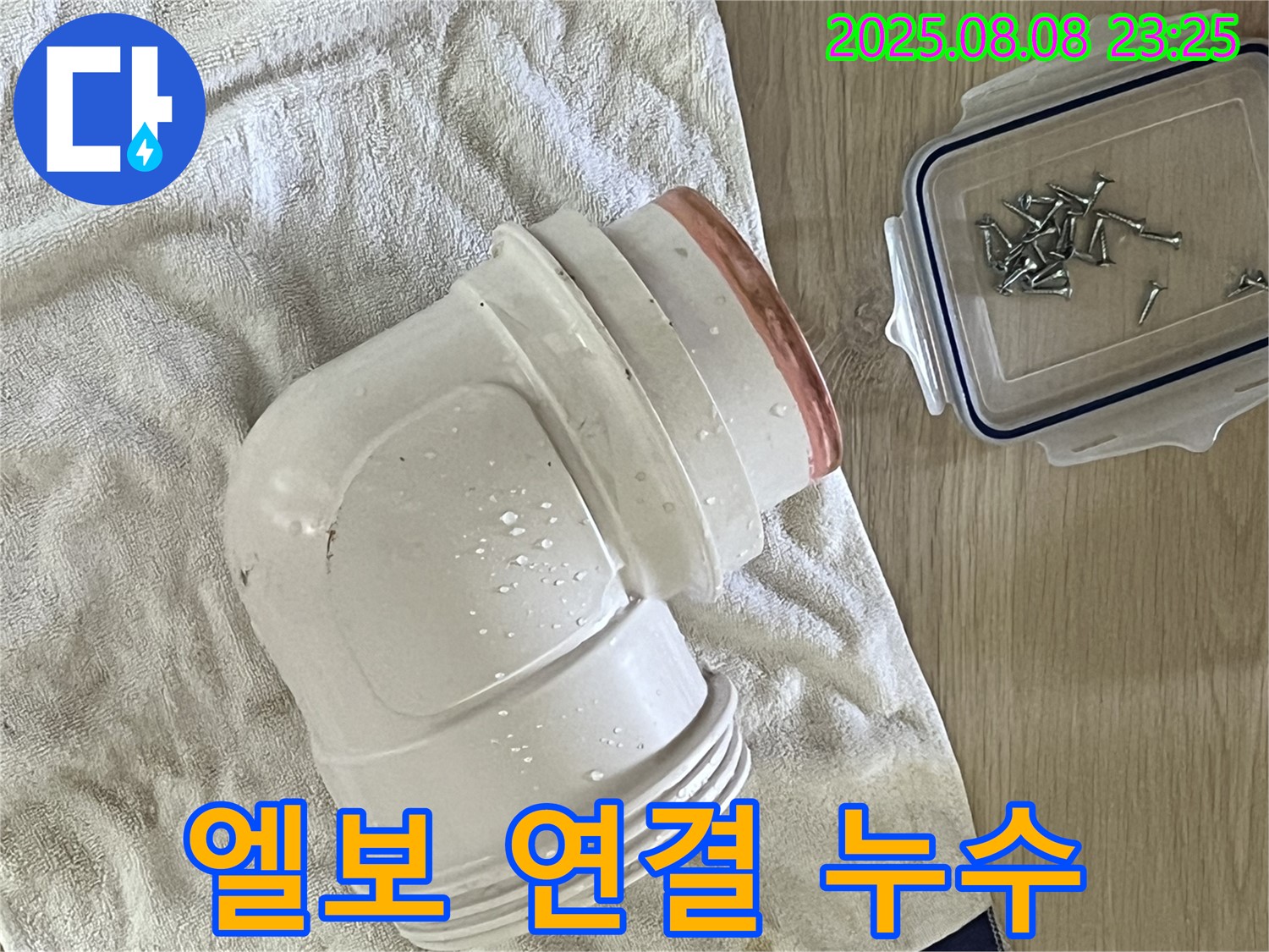 젖은 수건 위의 엘보 연결 부위 - 90도 엘보 연결 부위에서 누수가 발생한 모습입니다.
