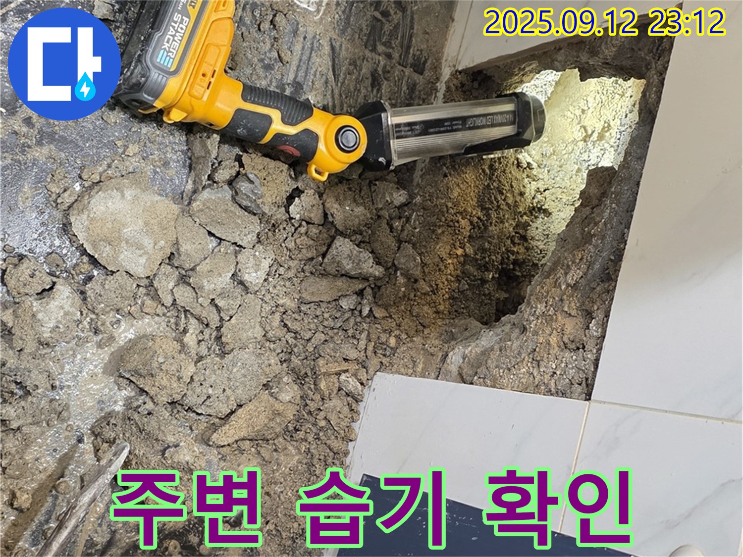 중계동 현대5차 아파트 누수 현장에서 - 타일 제거 후 주변의 습기 상태를 확인하고 있습니다.