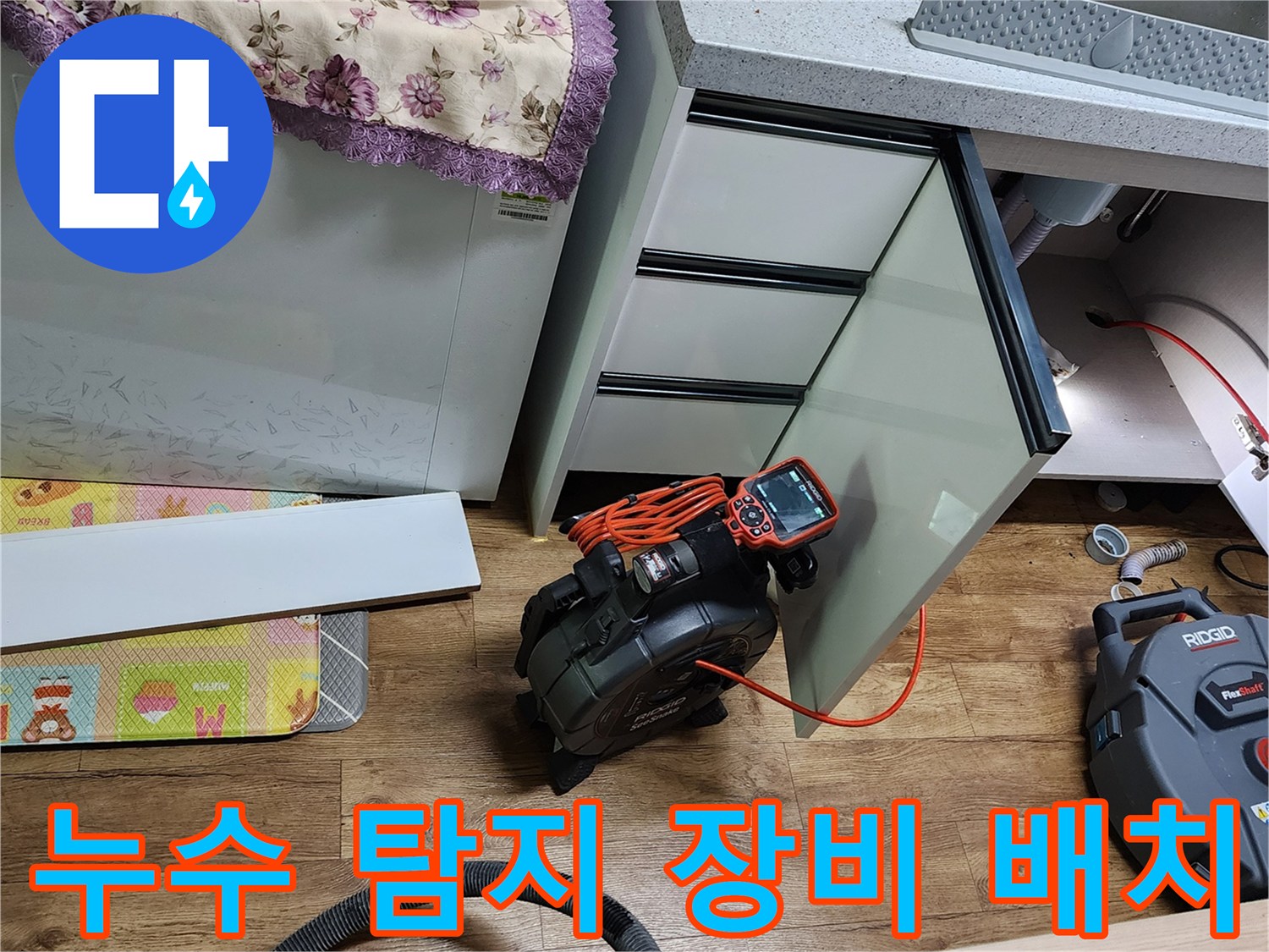 싱크대 아래 배관 누수를 찾기 위해 설치된 정밀 측정 기기