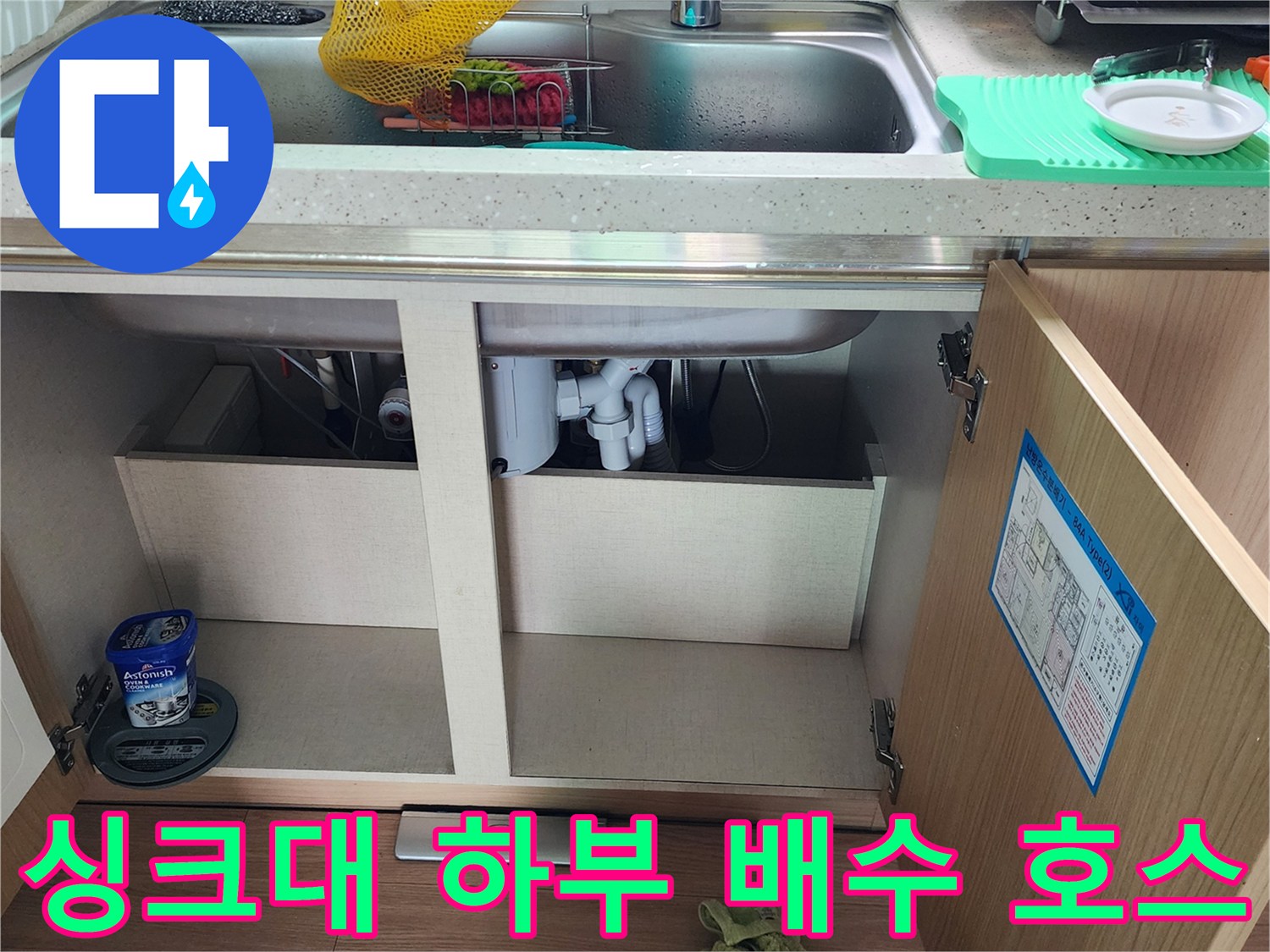 싱크대 아래쪽 배수구와 연결된 백색 배관의 근접 촬영 사진입니다.