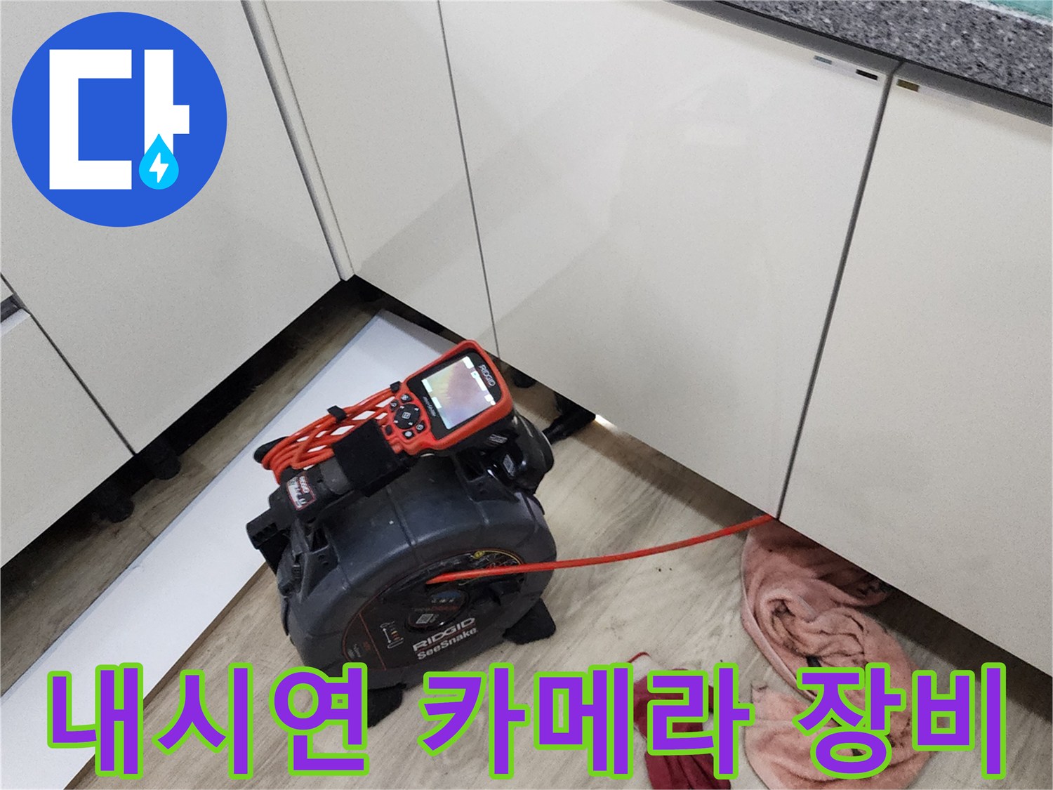 주방 싱크대 아래 공간에서 진행 중인 배관 내시경 검사 장면