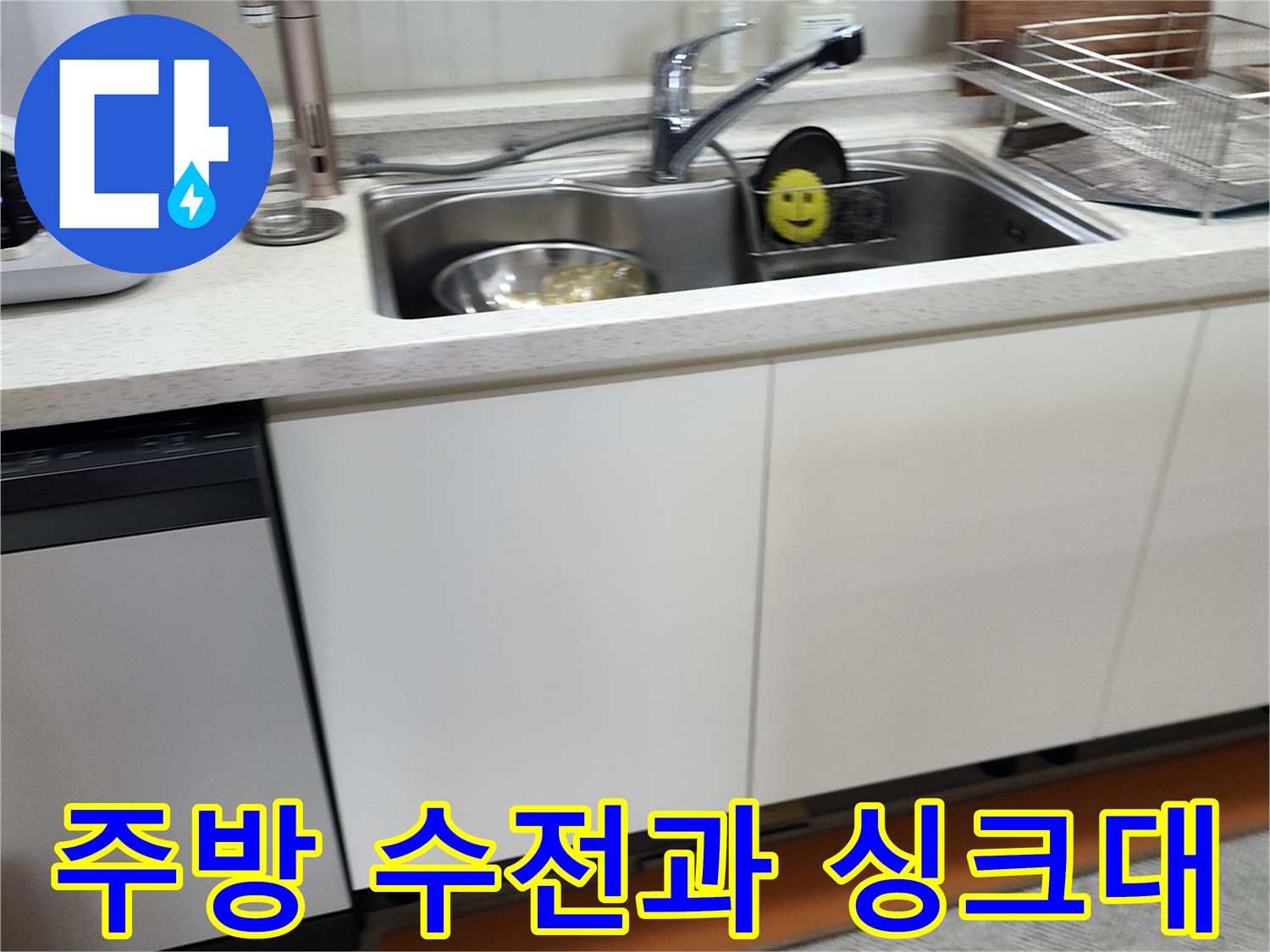 싱크대 상판에 설치된 수전과 배수구의 근접 촬영 이미지입니다.
