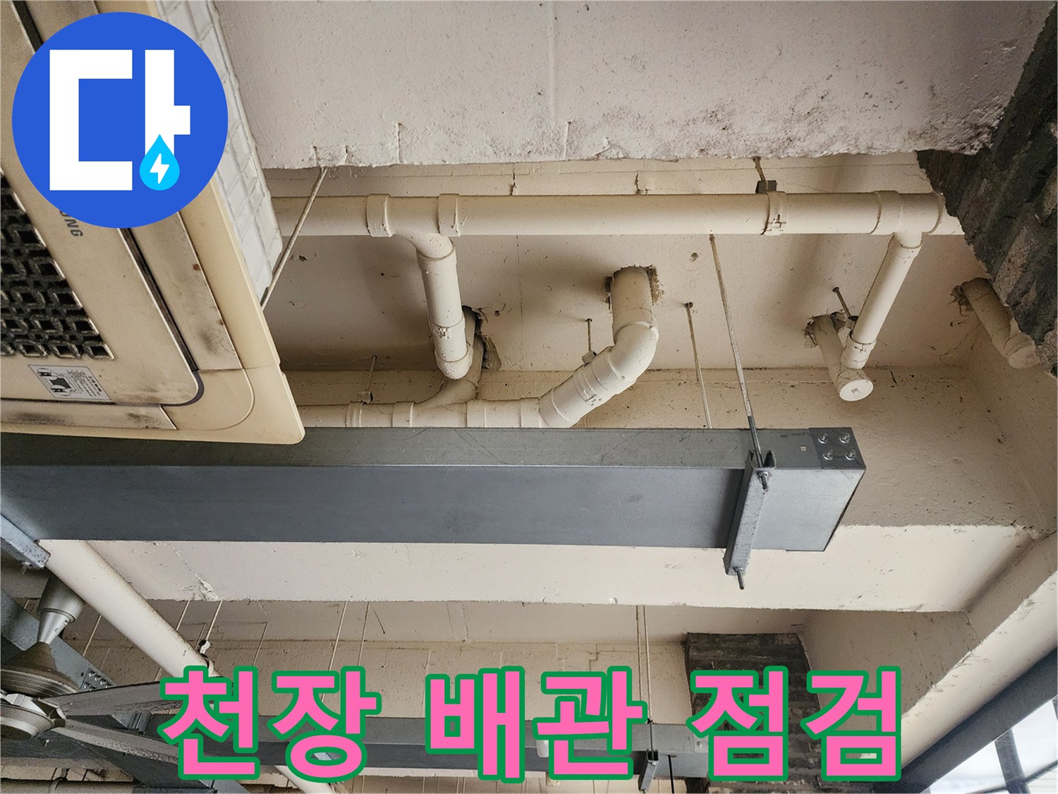 상가 천장의 노출된 흰색 배관과 에어컨 실내기 하단부