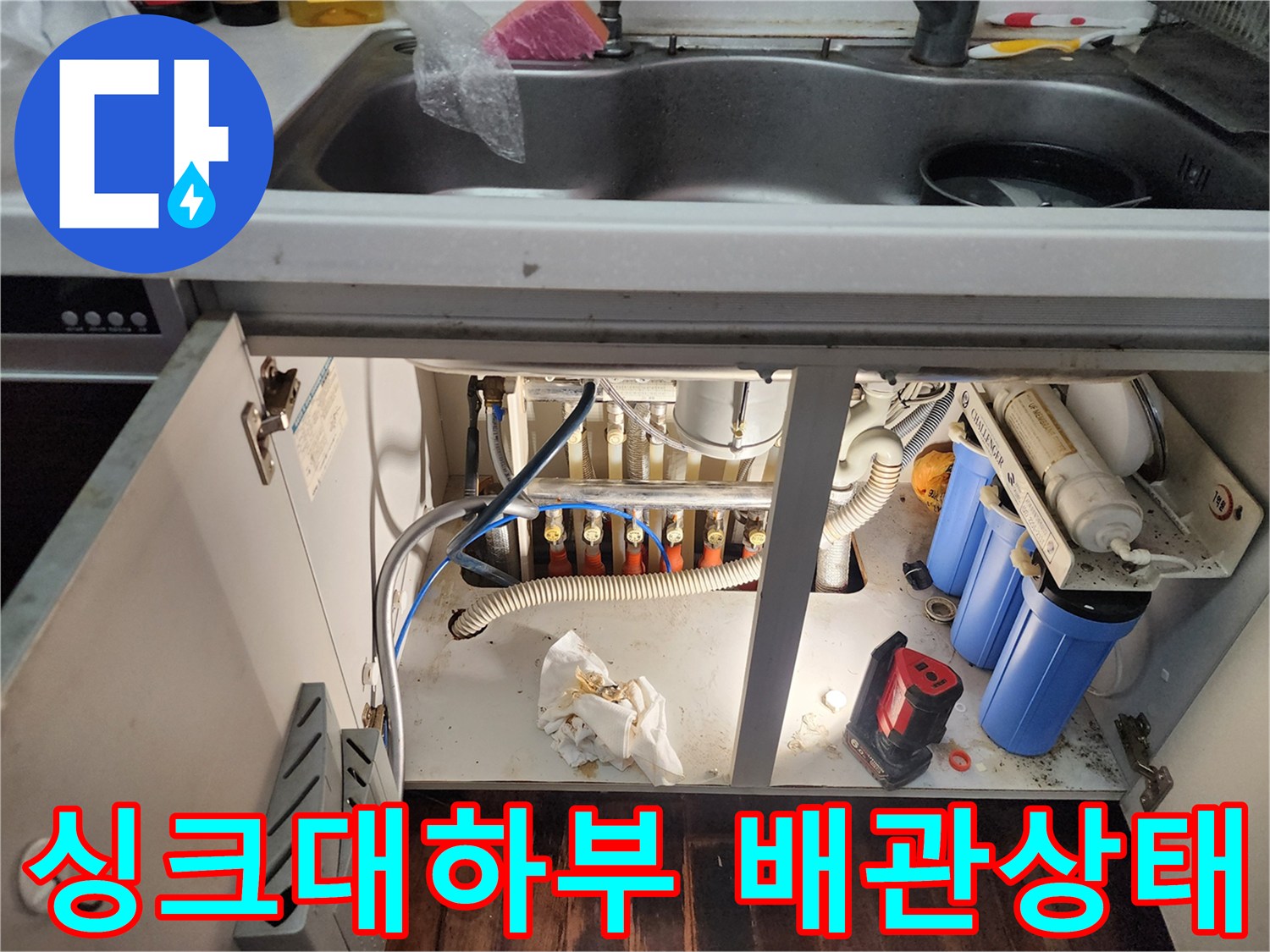 싱크대-하부장-내부의-복잡한-수도배관과-정수기-필터-모습