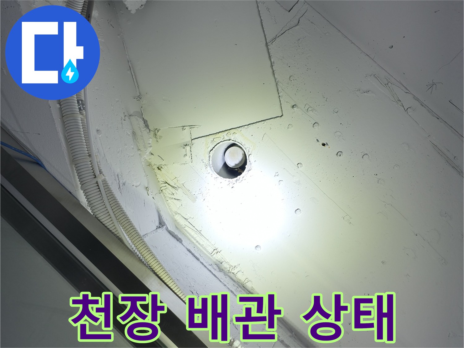 천장 마감재와 연결된 배관 및 전기 배선 구조