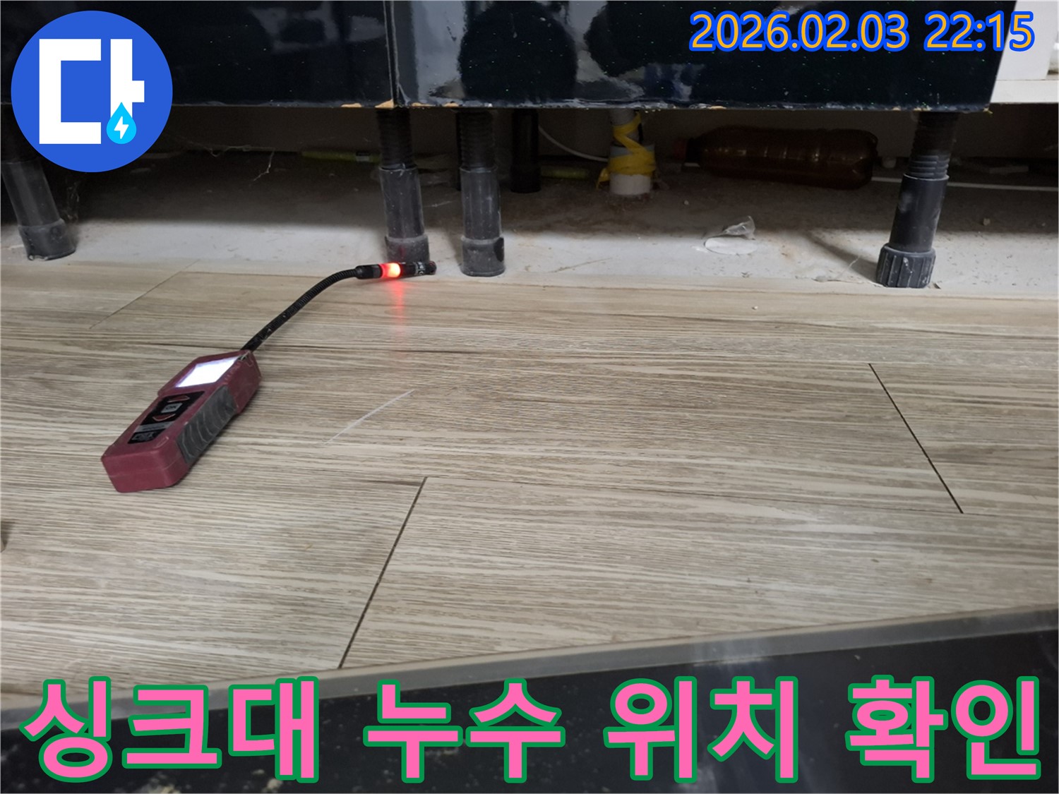 싱크대 아래에서 누수 탐지 장비로 누수 위치를 확인하는 모습 - 꼼꼼하게 확인하여 문제 해결!