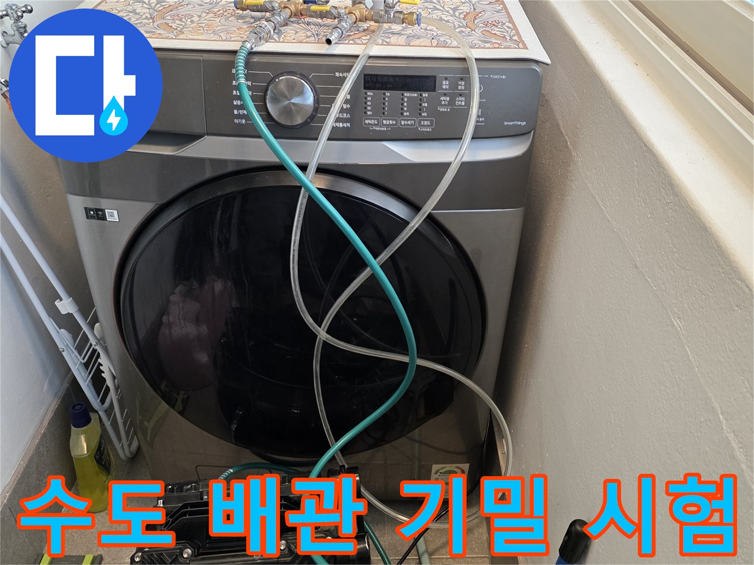 세탁기 주변 배관에 연결된 매니폴드 게이지와 공압 호스