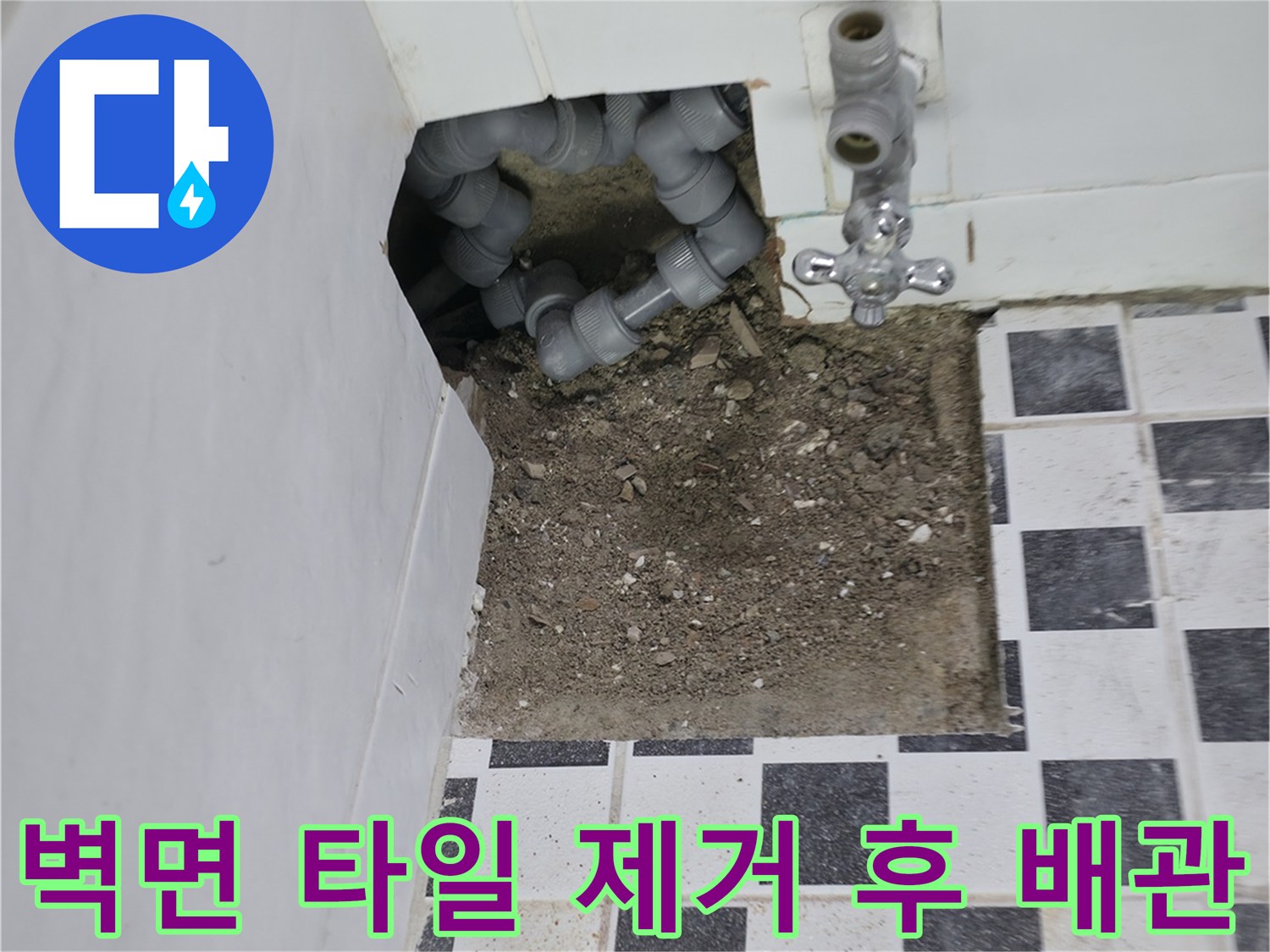 타일이 뜯겨나간 자리에서 보이는 회색 배관과 수전 부속