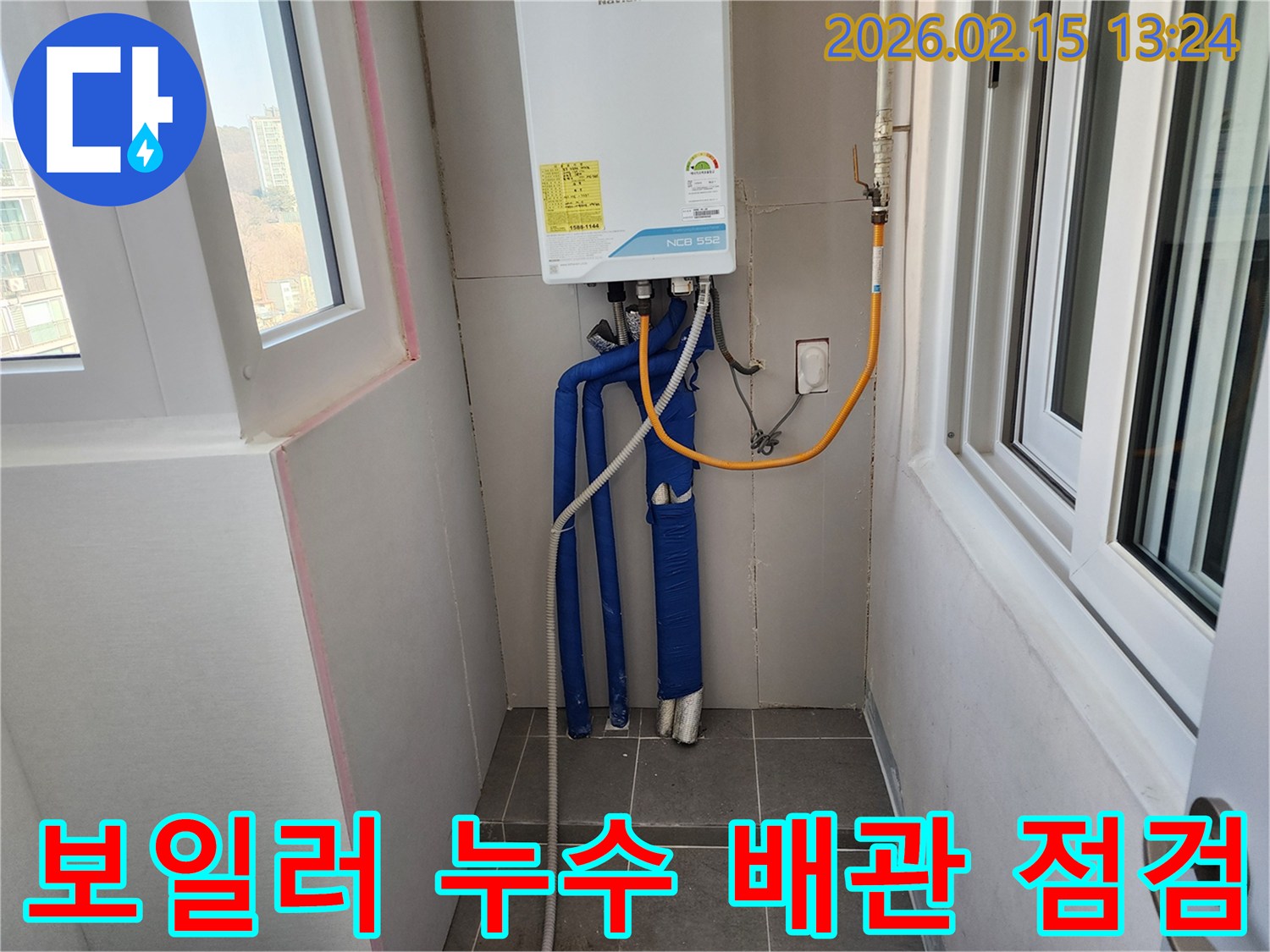 보일러 하단에 위치한 배관의 누수 여부를-전문가가 세심하게 점검하고 있는 모습입니다