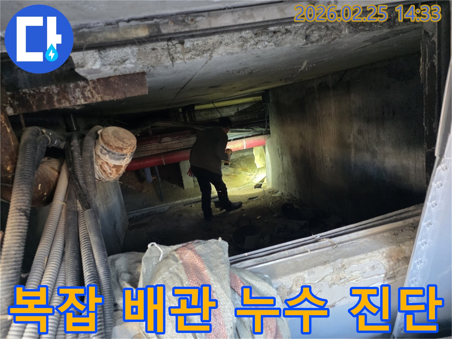 누수 엔지니어가-어둡고 좁은 공간에서-손전등으로-배관을-꼼꼼히-살피는 모습