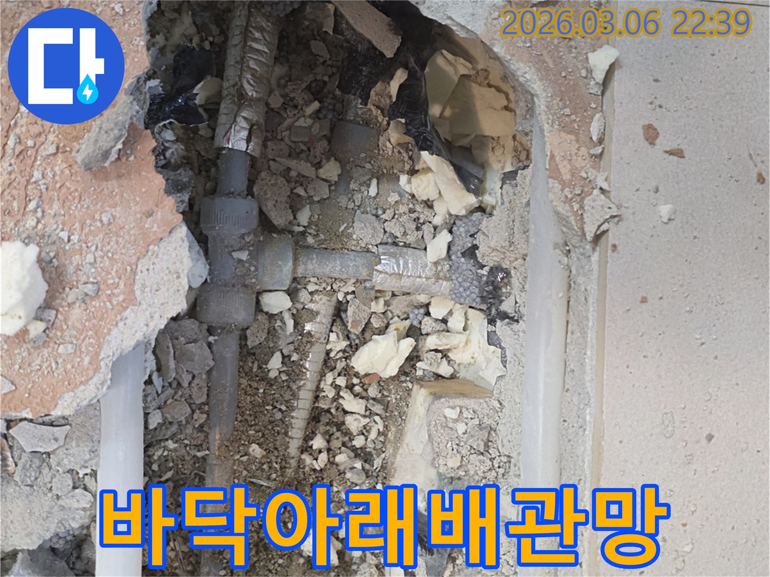 양주-백석읍-부흥로-주택에서-누수-전문가가-바닥을-개방하여-숨겨져-있던-복잡한-배관망을-드러내고-누수-원인을-확인하는-모습입니다.