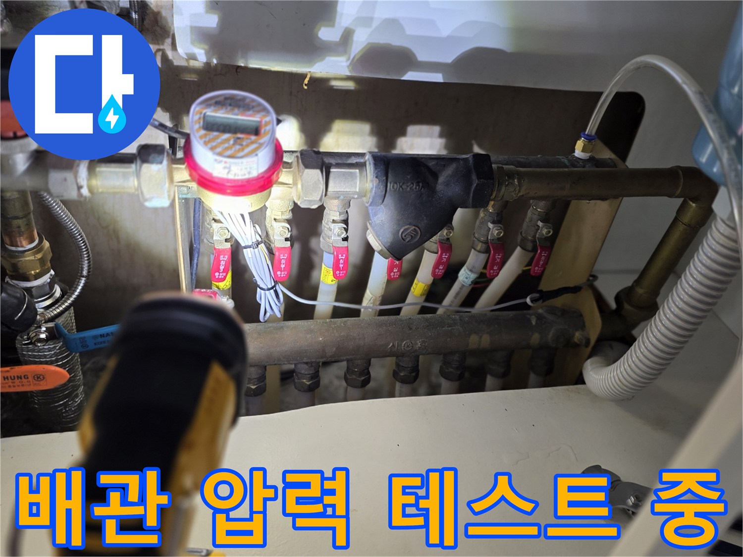 분배기에 연결되어 압력을 측정하고 있는 전문 장비와 배관 모습입니다.
