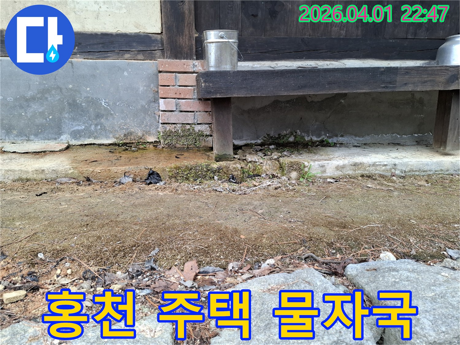 주택 외부 기초부의 지속적인 습기 노출로-변색과 이끼가 발생한 모습을 담은 이미지