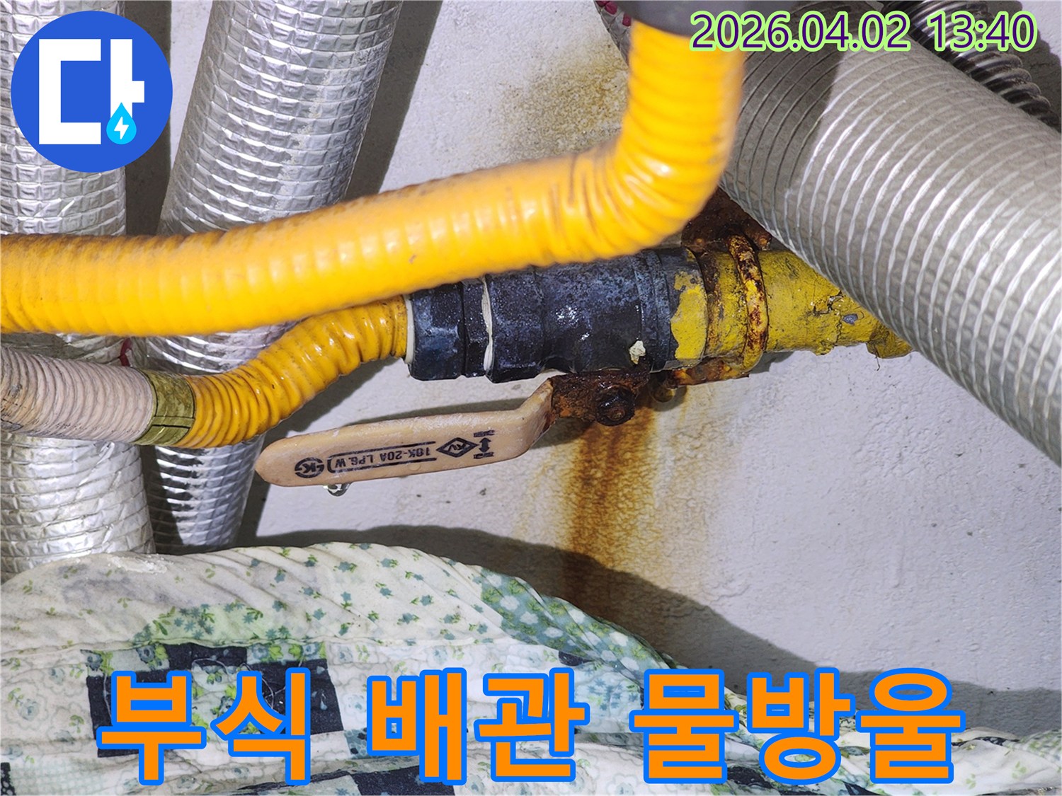 부식된 배관 연결부에서 물방울이 맺혀 떨어지는-긴급한 누수 상황을 보여주는-즉각적인 수리가 필요한 현장 이미지