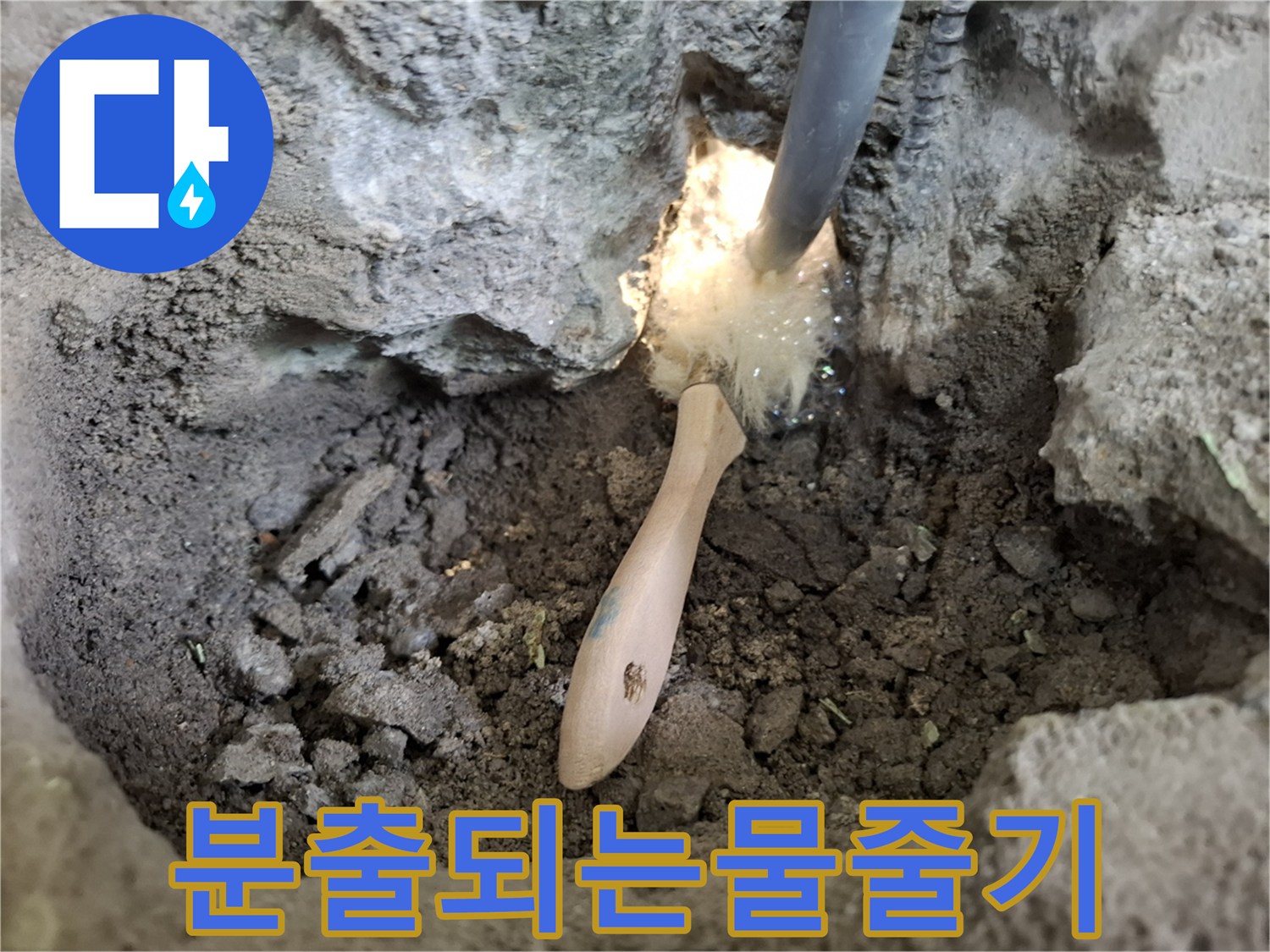 파손된 배관 사이로 물이 솟구치고 있는 작업 현장 사진입니다.