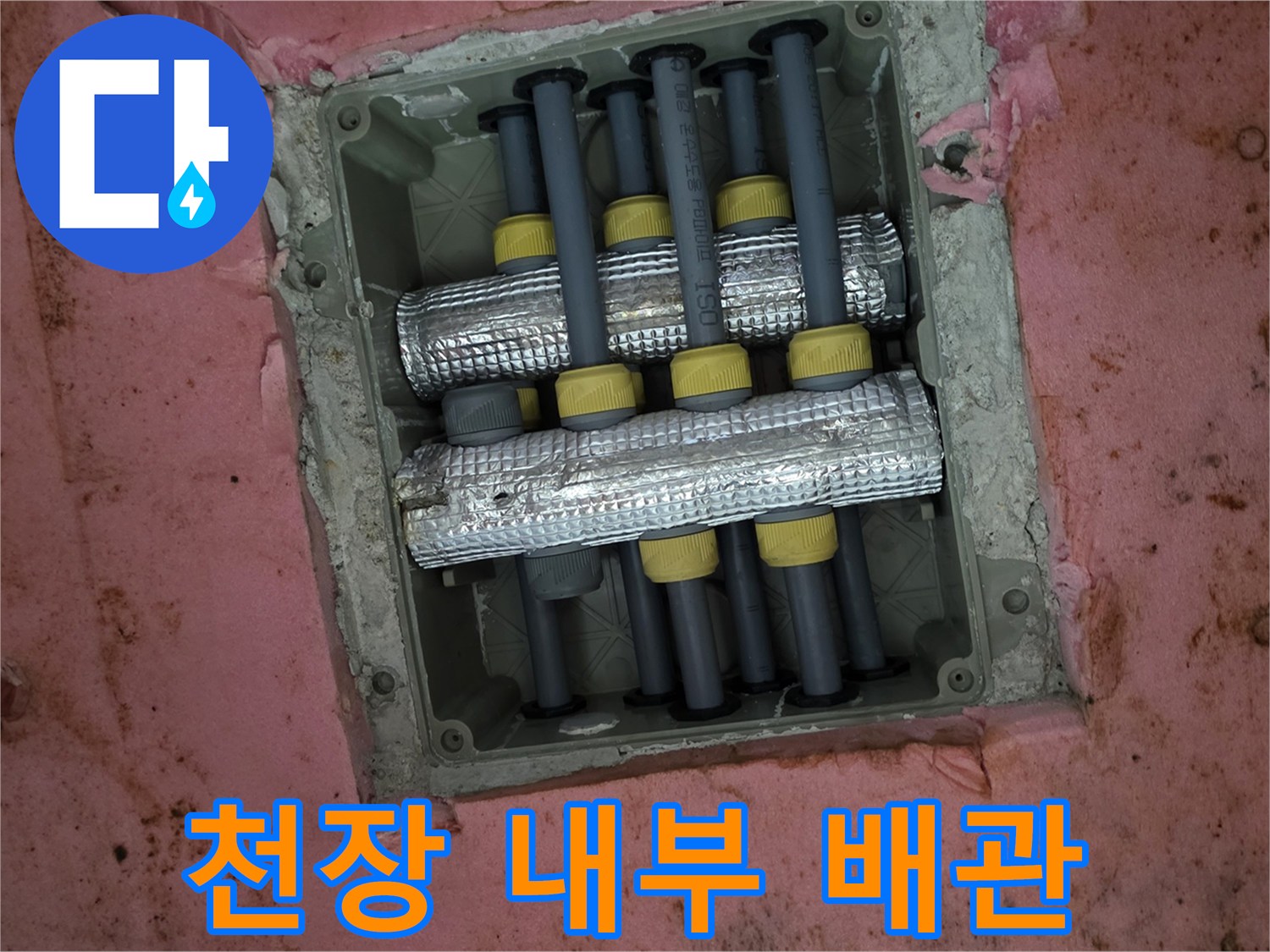 천장 점검구 안쪽의 은색 보온재로 감싸진 배관들