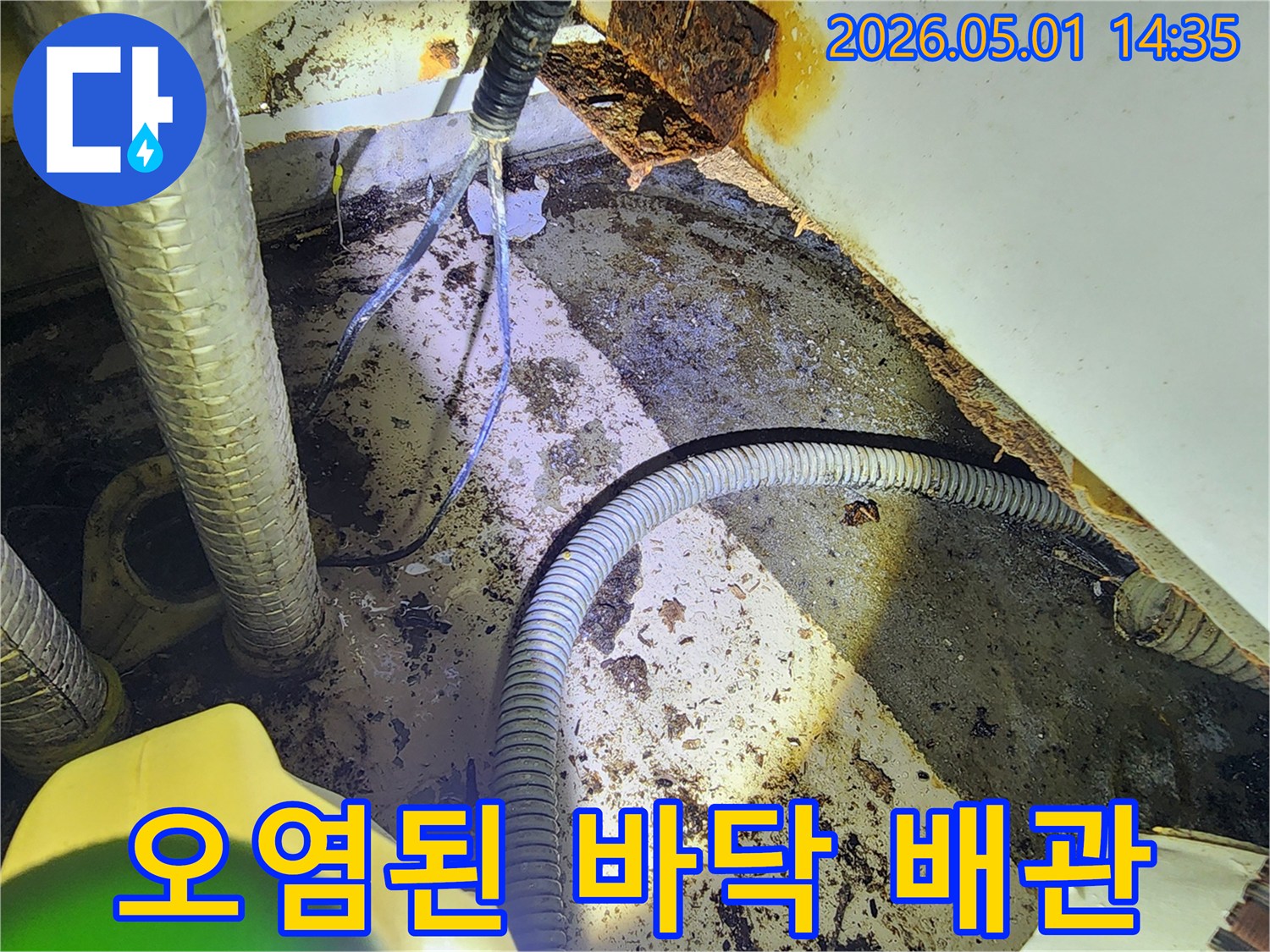 중동역 푸르지오 아파트의-오염된 바닥 배관과-주변 부식 현장을 보여주는 사진입니다