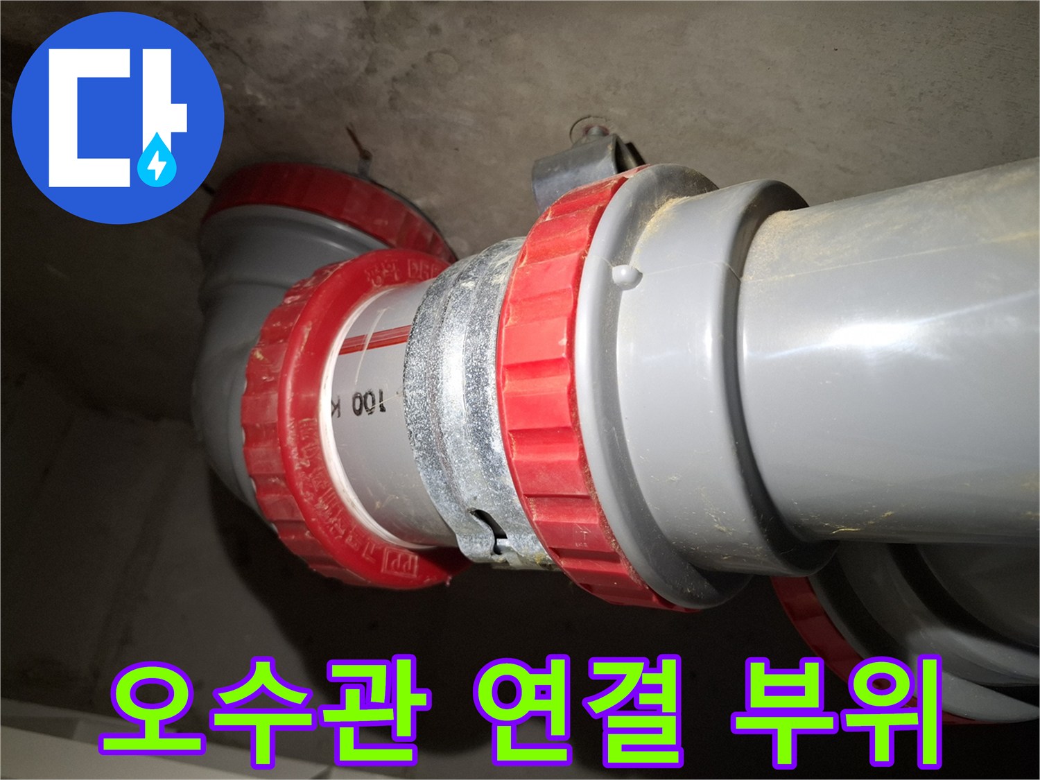 천장에 노출된 100mm 오수관과 빨간색 패킹이 있는 배관 부속
