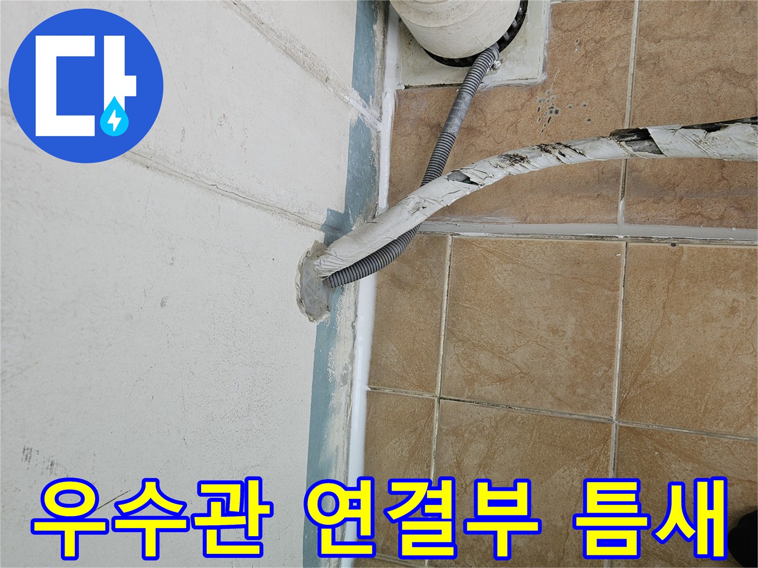 베란다 우수관 주변의 벌어진 타일 틈새와 배관 상태입니다.