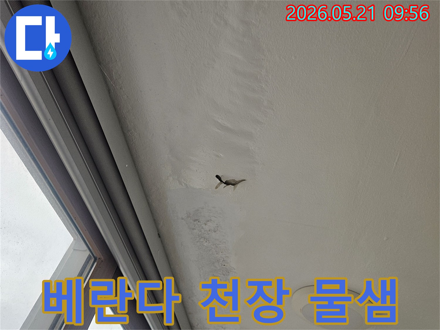 베란다 천장에서 물이 새어 벽면이 젖고-얼룩이 생긴 누수 피해 현장을 담은 사진입니다.