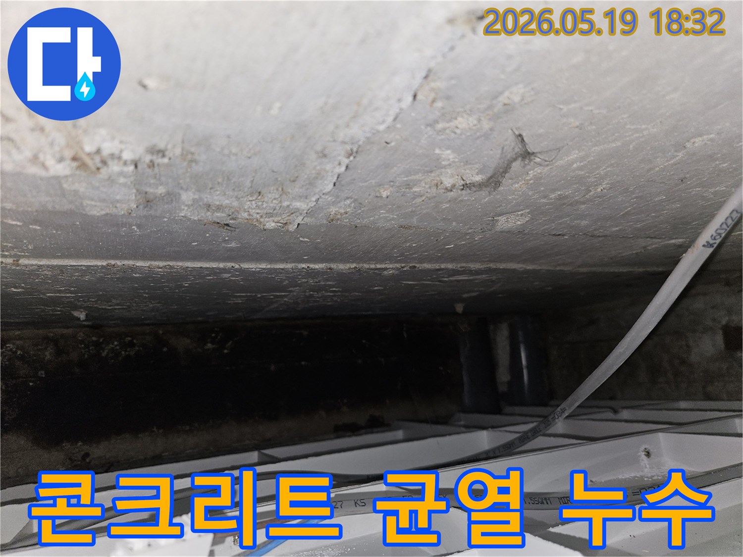 어두운-공간-속-천장-콘크리트의-균열과-물샘-흔적을-담은-사진