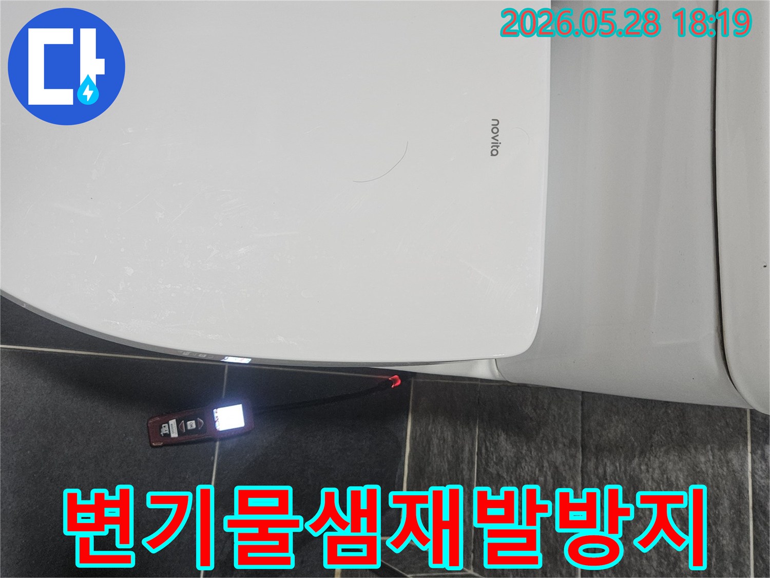 누비타 변기 옆-바닥 타일 틈새에서-누수 탐지기가-빨간 불빛을 내며-누수 지점을 가리키고 있습니다.