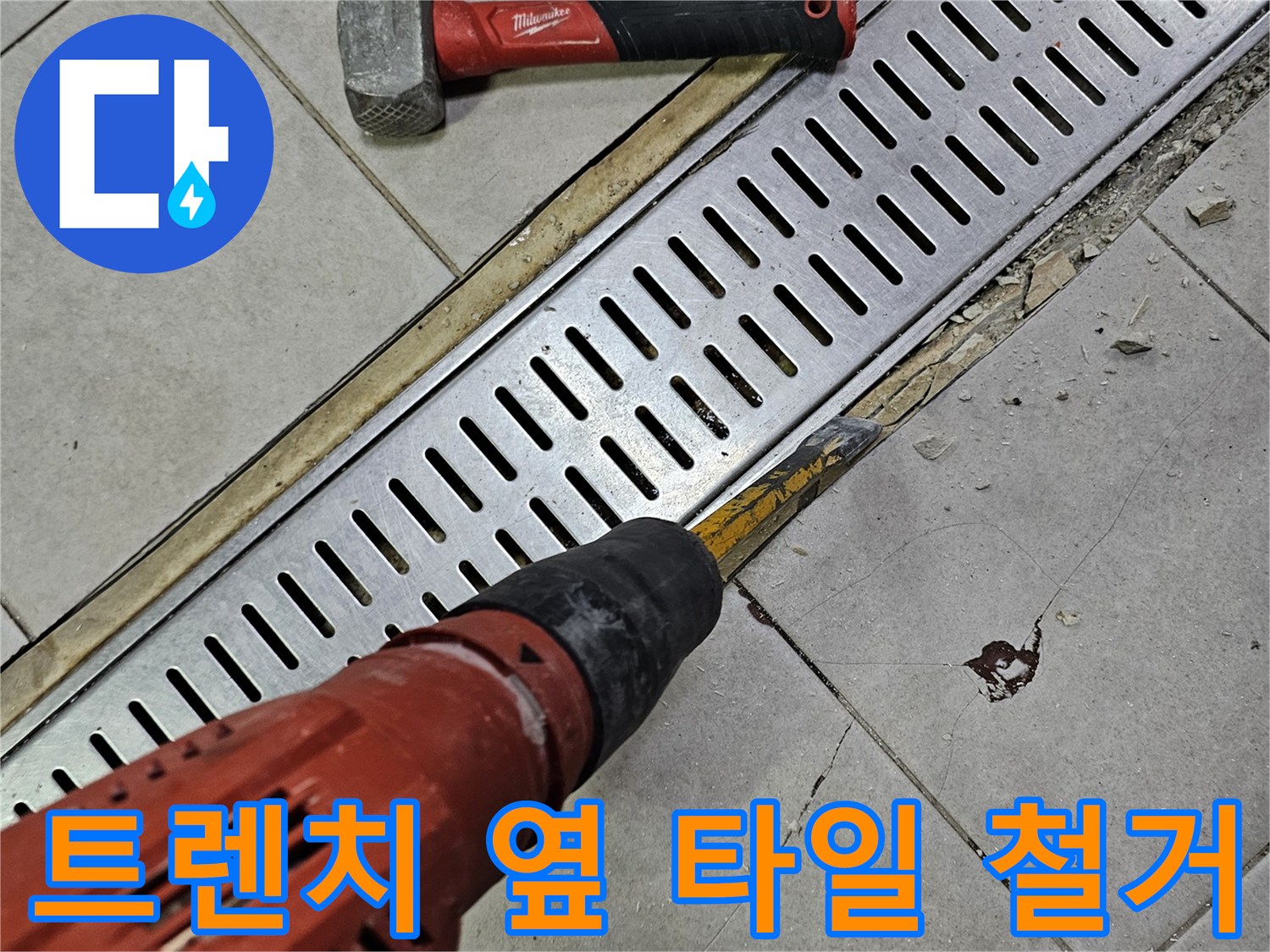 드릴을 이용하여 트렌치 주변의 타일을 제거하고 있는 사진