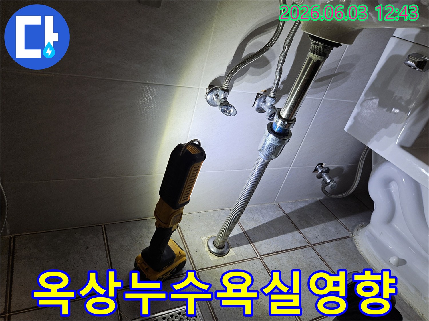 화장실 배수관 주변을-정밀하게 점검하기 위해-사용된 강력한 조명이-누수 흔적을 드러내고 있습니다.
