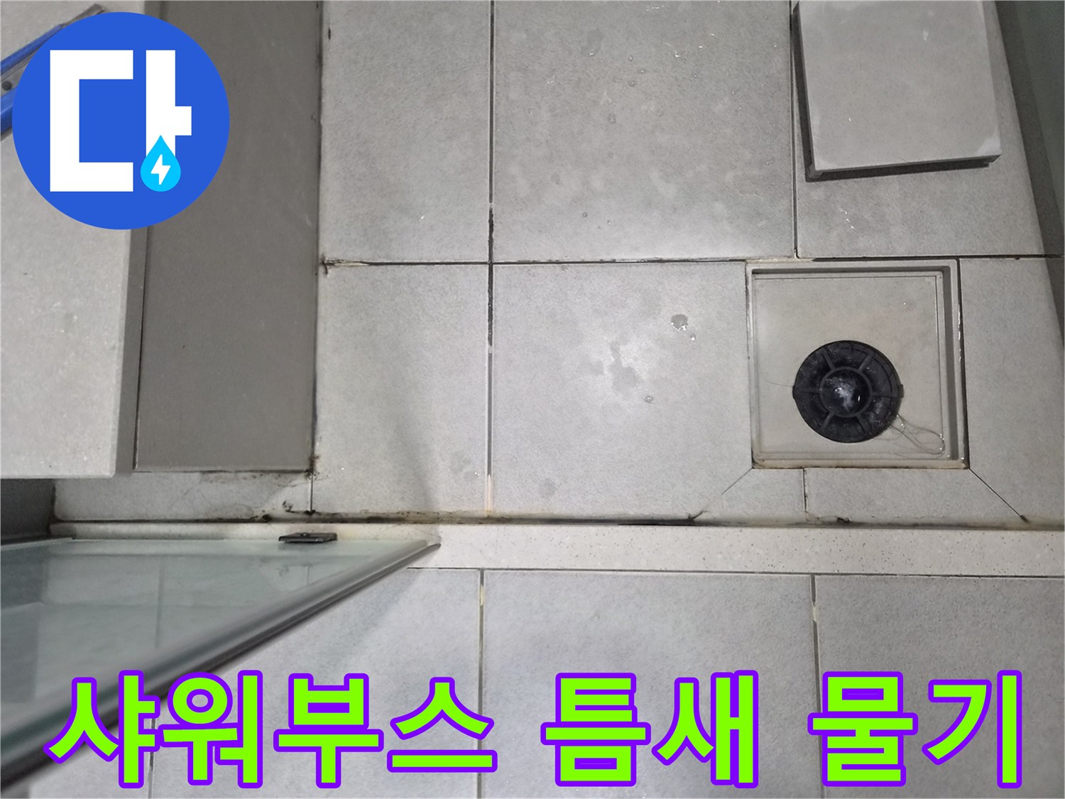 샤워부스 유리벽과-바닥 타일 사이의-틈새에서 발견된-물기 흔적을 점검하는 이미지