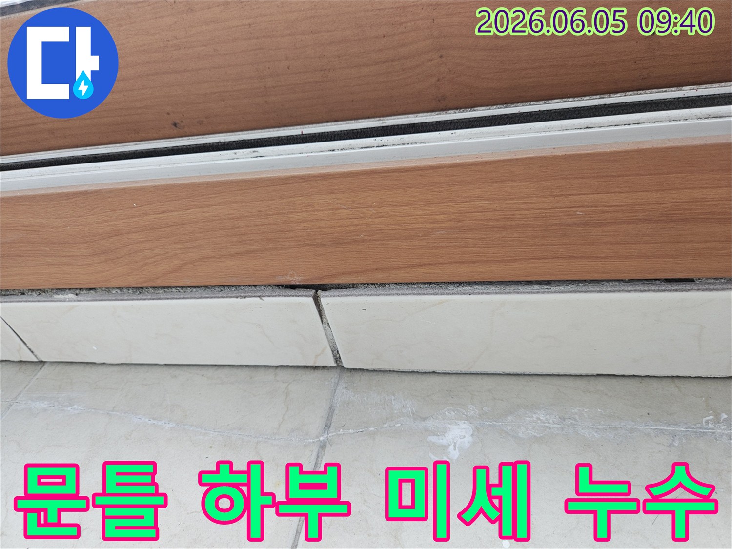 목재-문틀-하부와-타일-경계면의-미세한-물샘-증거를-보여주는-이미지