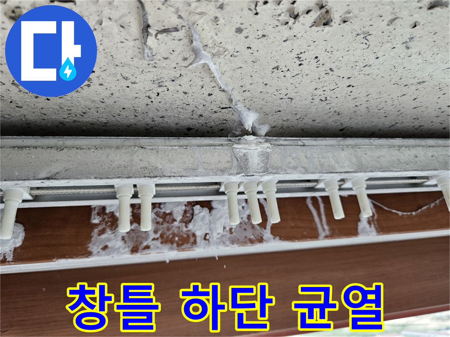 창틀 아래 콘크리트 면에 발생한 크랙과 수분 침투 흔적