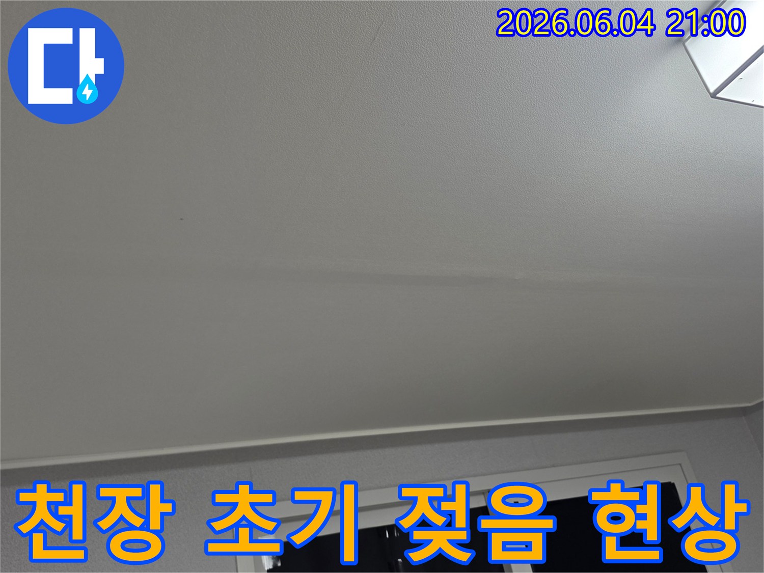 천장 표면에 나타난-누수의 초기 단계인-희미한 젖음 현상을-정확히 기록한 사진입니다