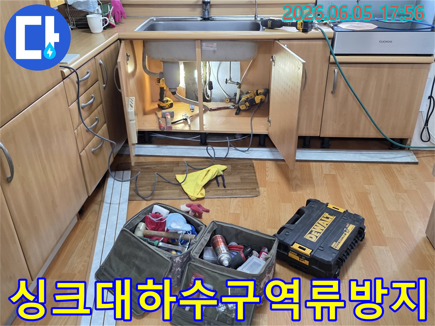 싱크대 하부의 하수구-역류 방지 작업을 위해-전문 공구들이-준비된 작업 현장입니다.
