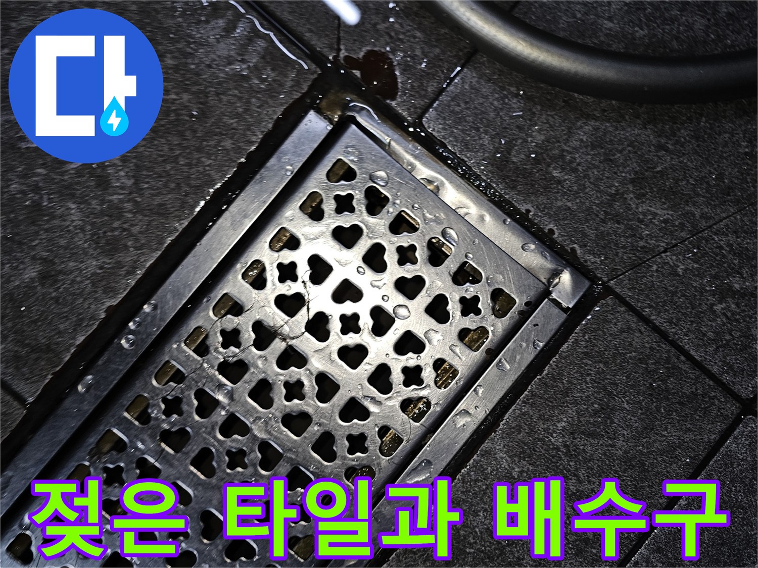 물기가 고인 타일-배수구 주변의 누수 흔적을 촬영한 사진