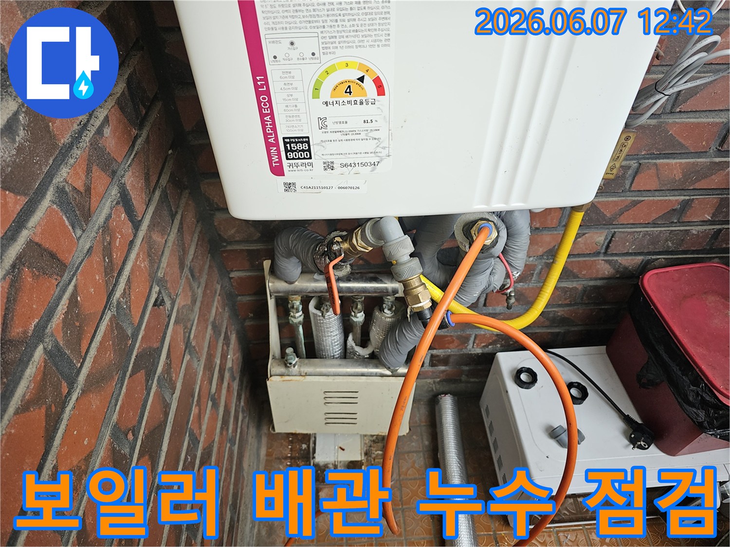 이 이미지는-서울 금천구 독산동의 한 주택에서-가스보일러의-배관 연결 부위에서-발생한 누수를-엔지니어가-정밀하게 점검하는-모습을 담고 있습니다