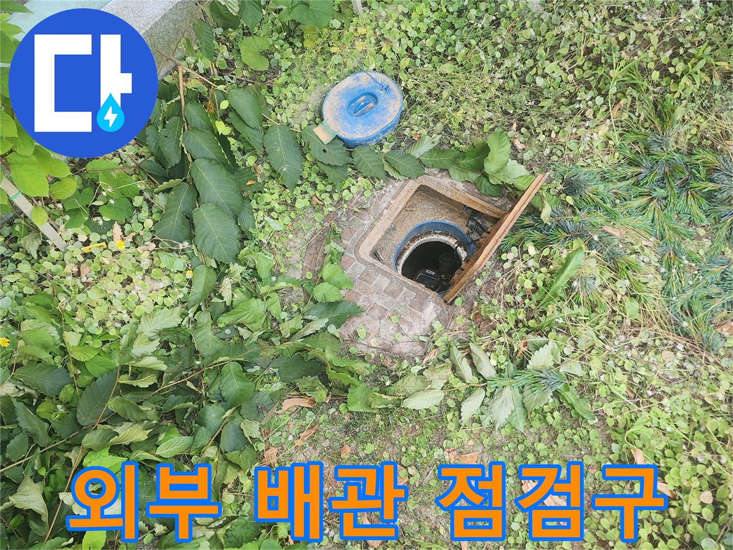 건물 외곽-배관 점검을 위해 열어둔 맨홀 부위