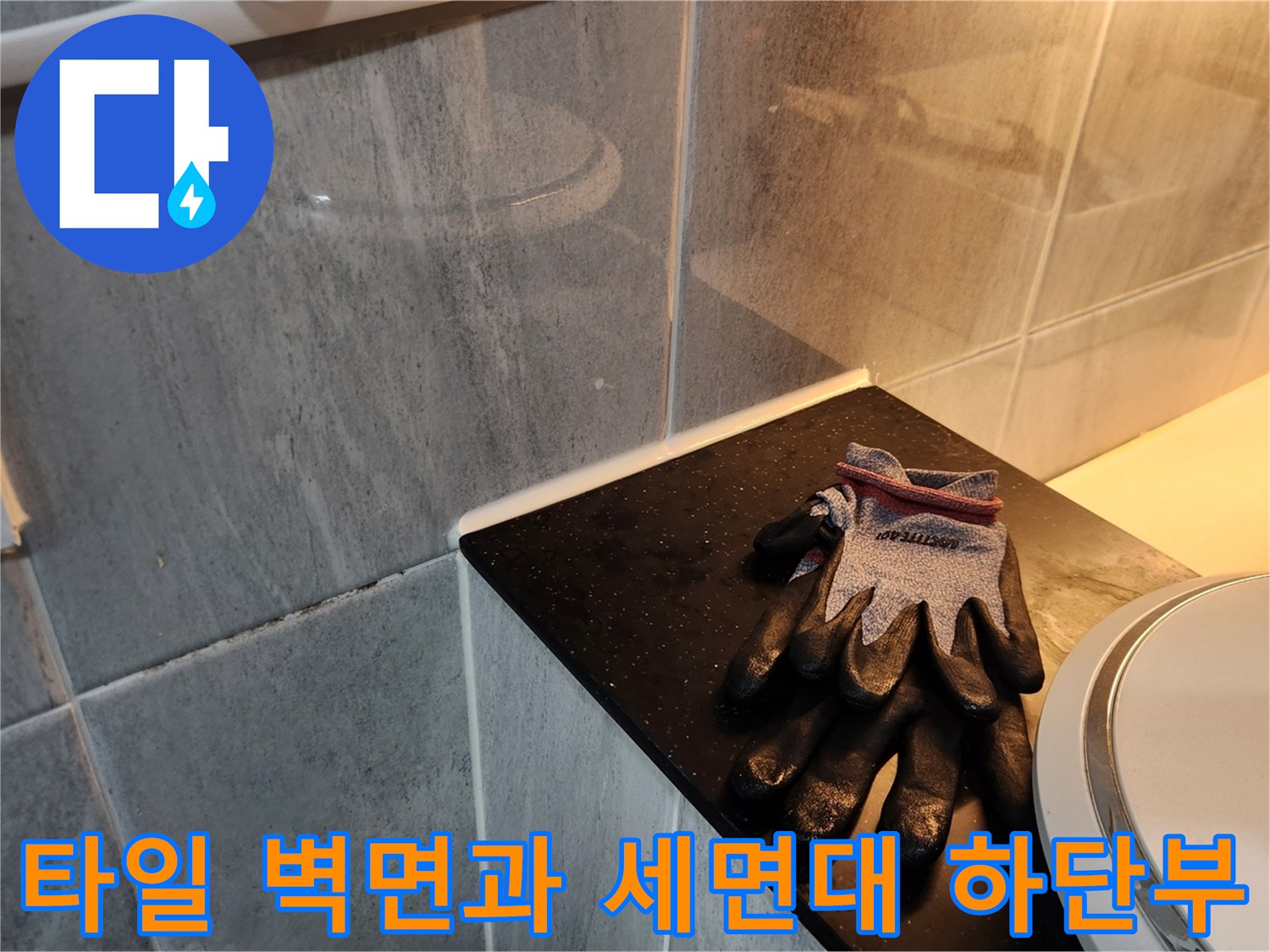 욕실 타일 벽면과 세면대 근처의 작업 도구