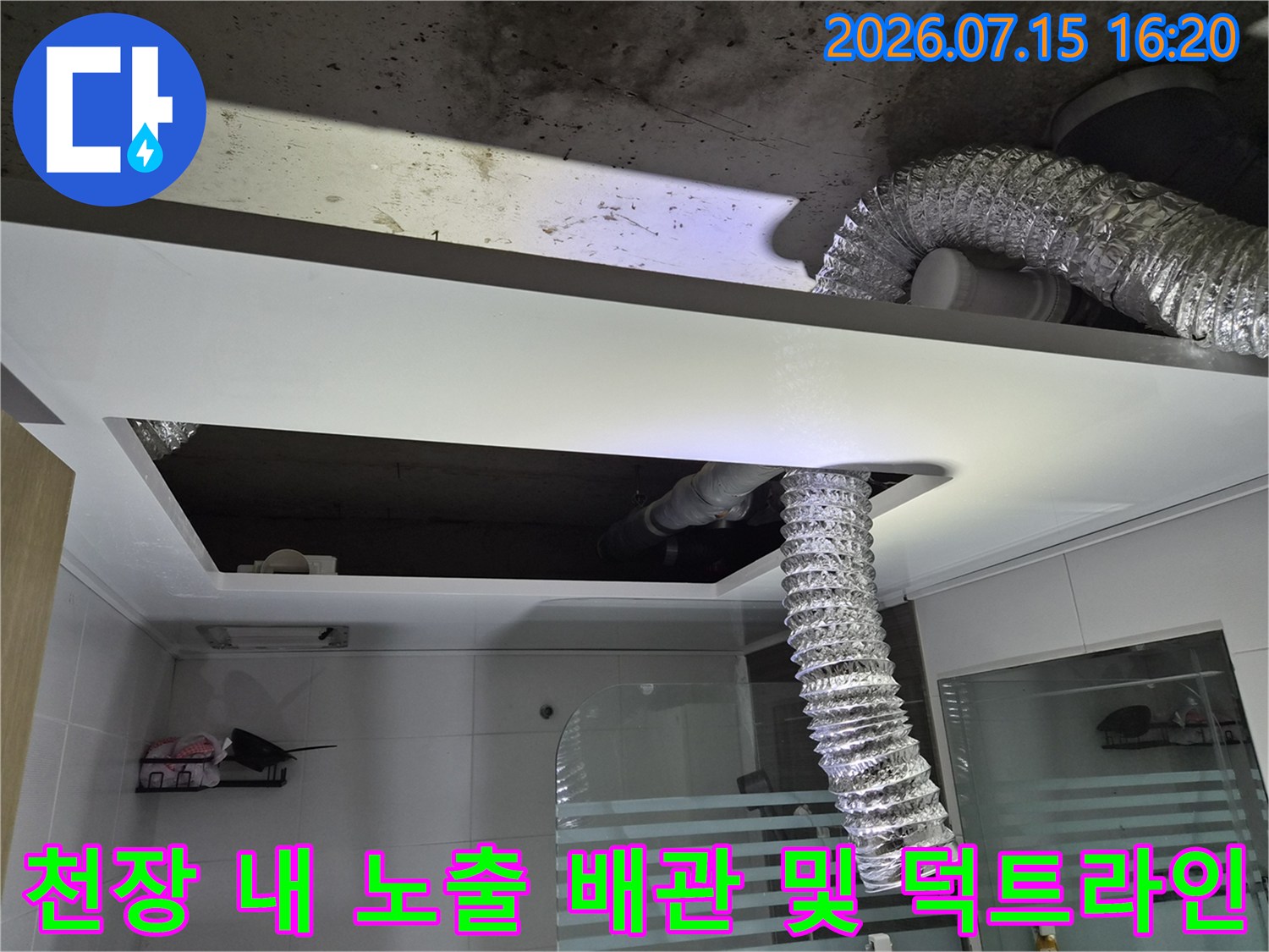 은색으로 감싼 환기용 굴곡형 덕트와 천장 내부의 배관 시스템