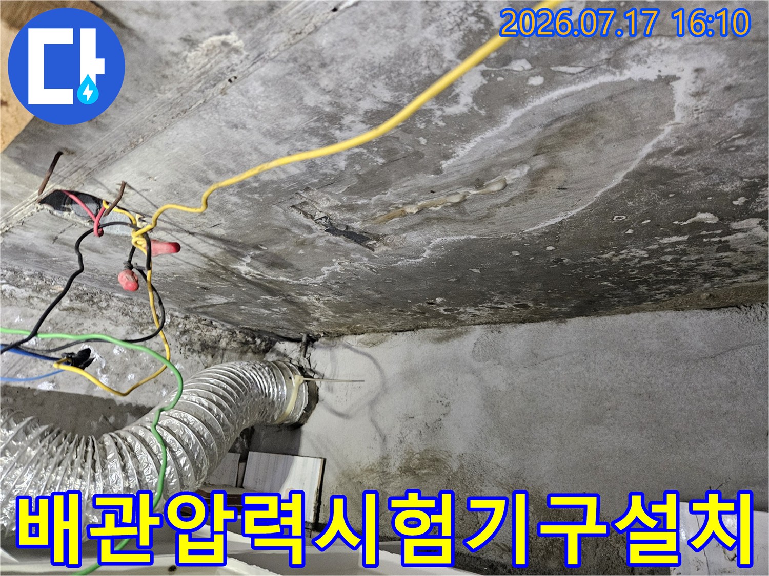 화장실 천장에서 배관 압력을 체크하기 위해 장비를 연결한 모습