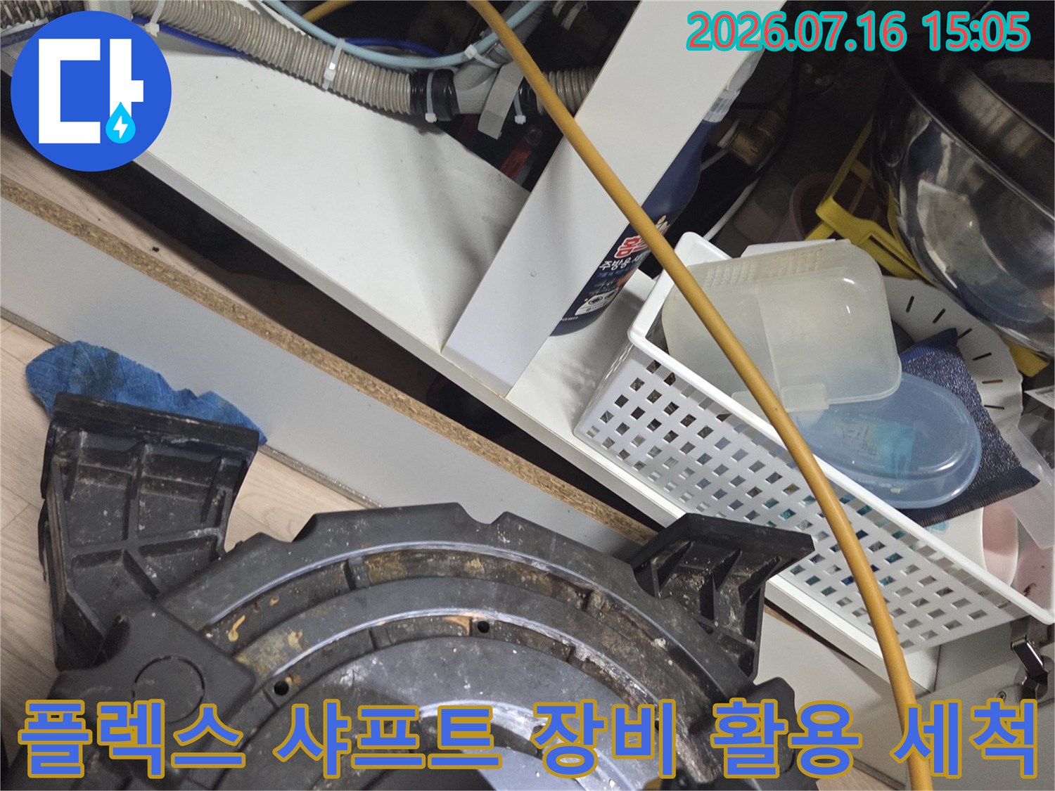 싱크대 하부 공간에서 배관 내벽의 찌꺼기를 제거하는 플렉스 샤프트 작업 장면