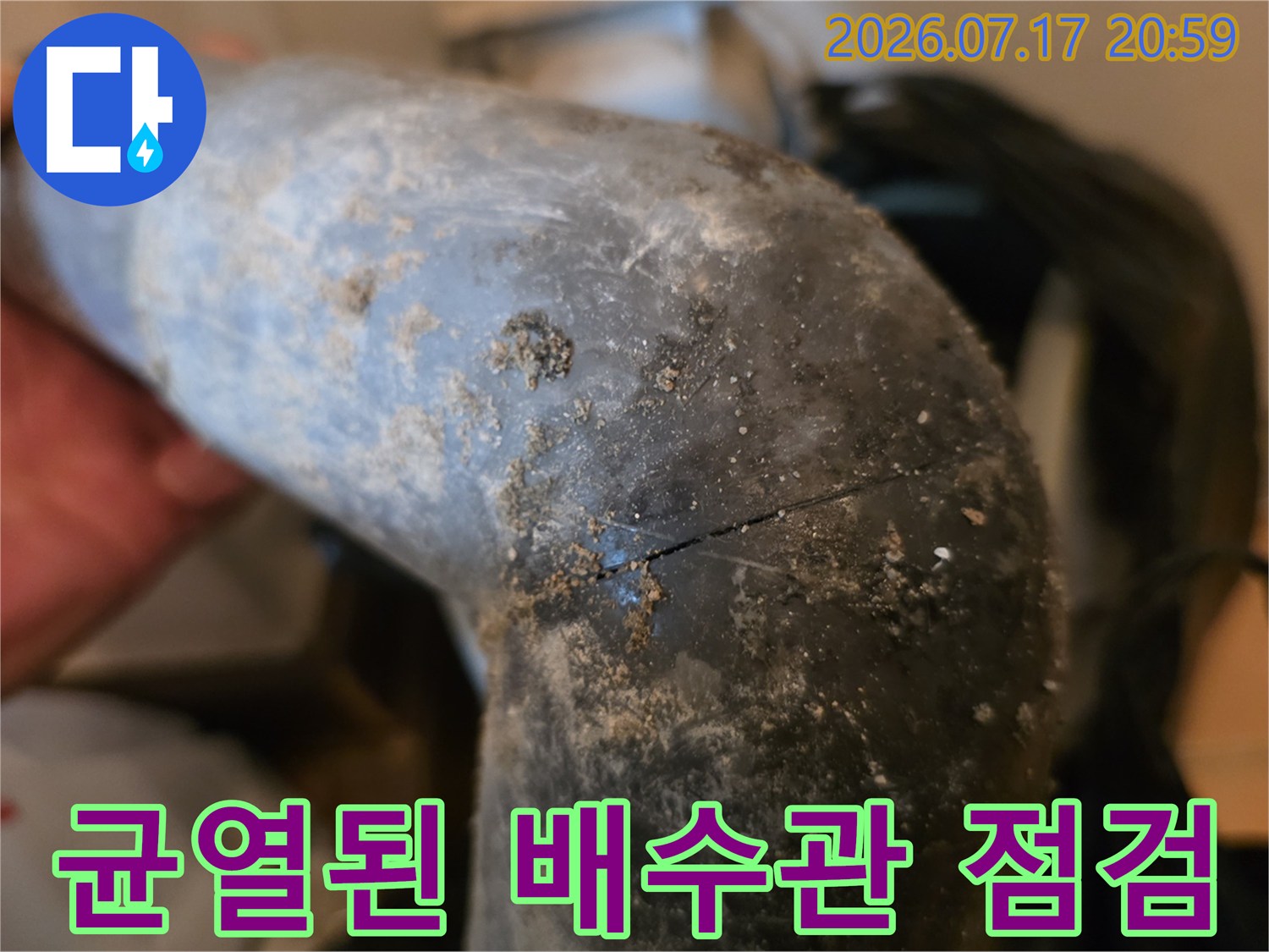 갈색 이물질이 묻은 배수관에 발생한 균열과 파손 부위