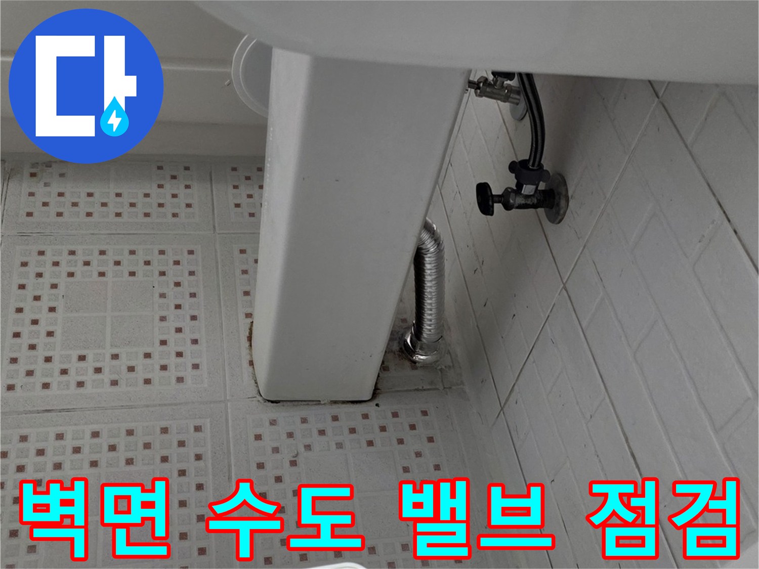 벽면 타일 사이로 연결된 급수 밸브와 호스 사진입니다.