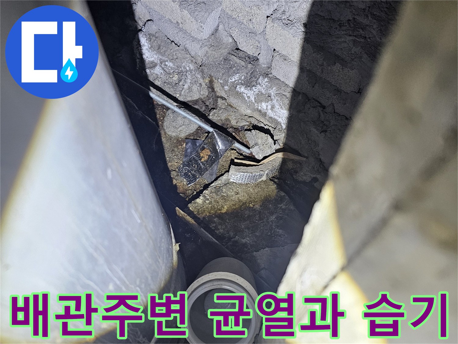 지하 주차장 배관 주변의 크랙과 젖어있는 바닥 상태를 보여주는 사진입니다.