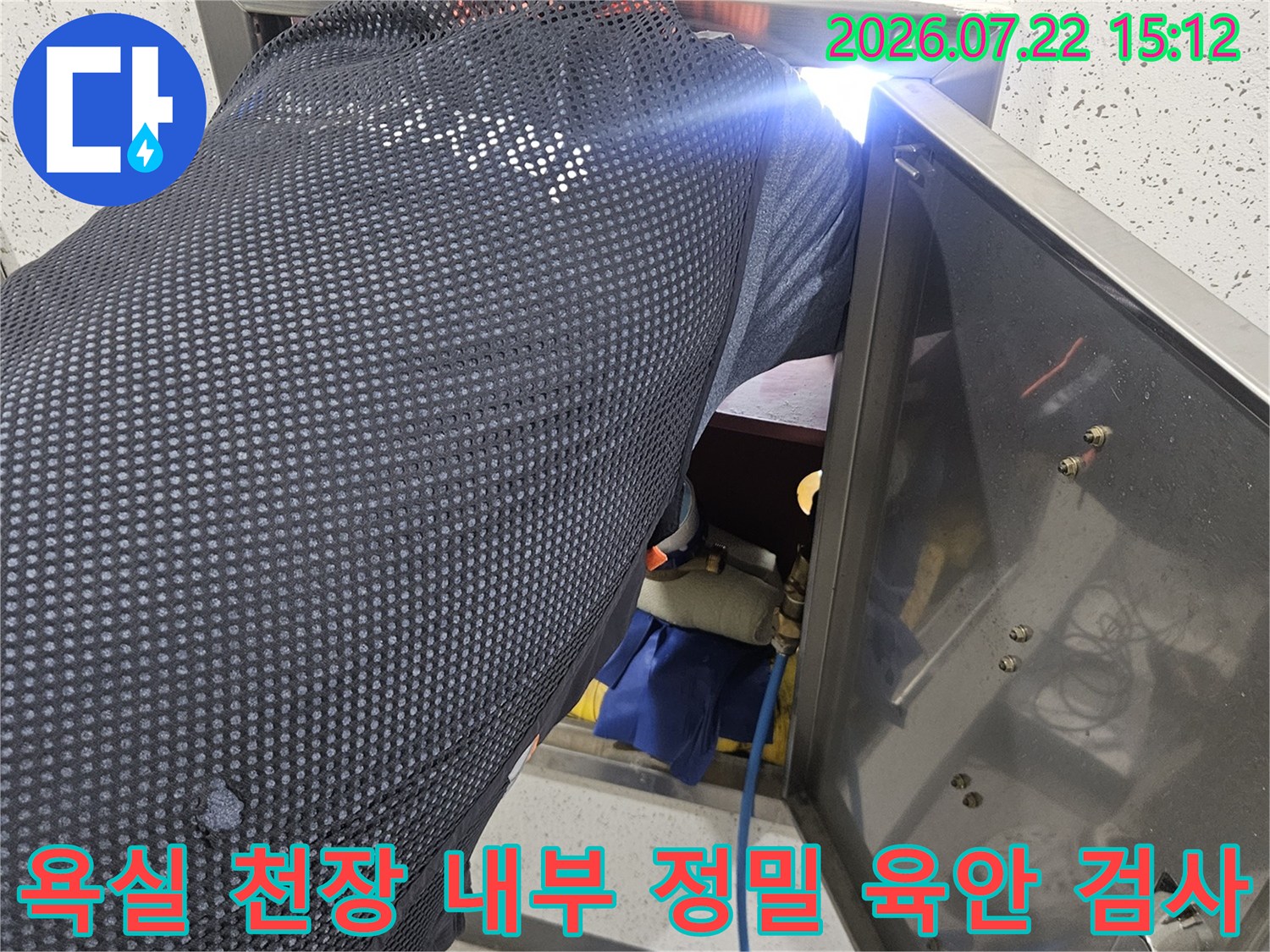 금속 소재의-천장 점검구 덮개를 들어 올리고 내부를 확인하는 작업 사진