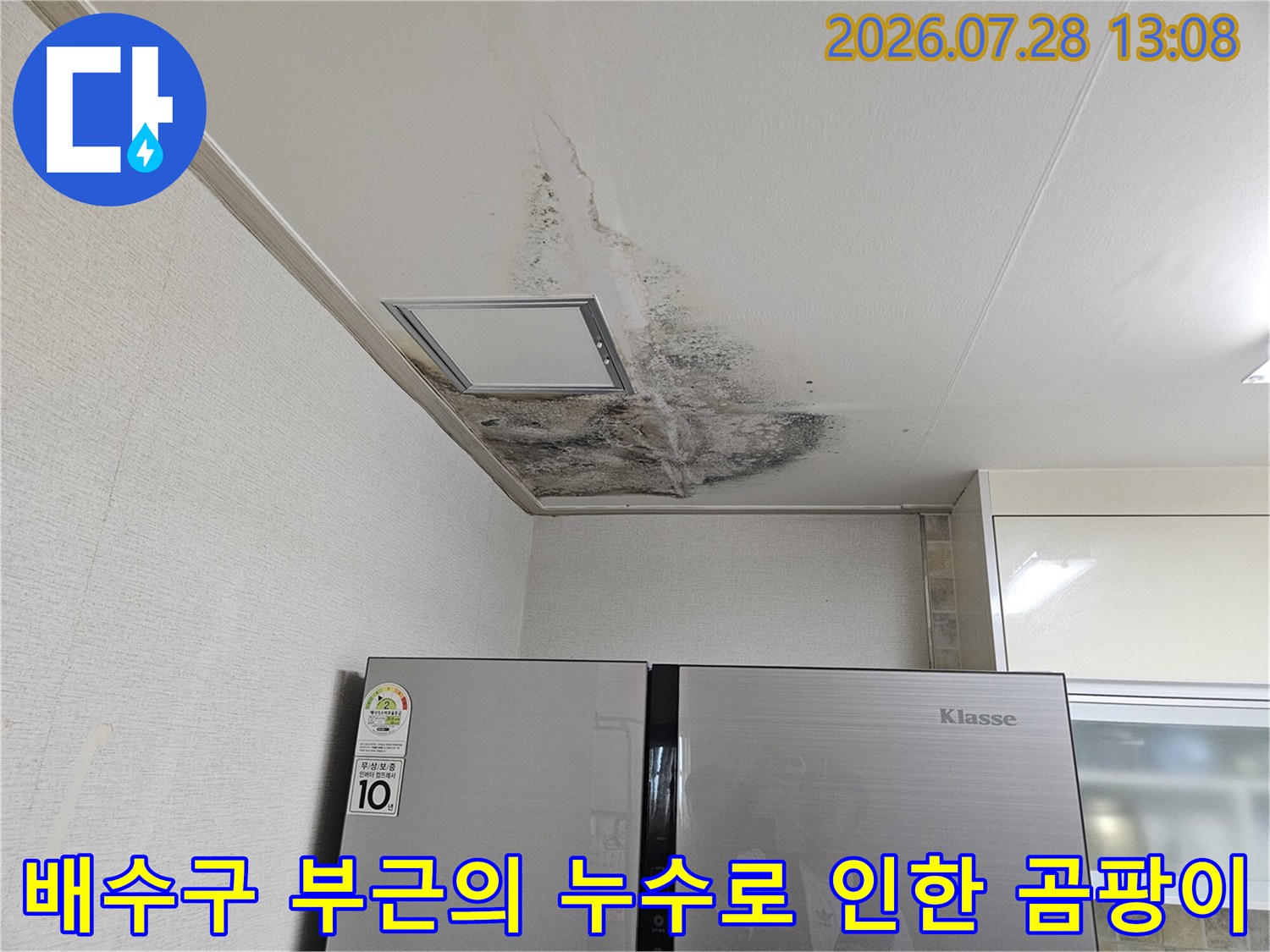 노후된 배수관 연결부 주변으로 넓게 퍼진 수분 자국과 곰팡이 오염
