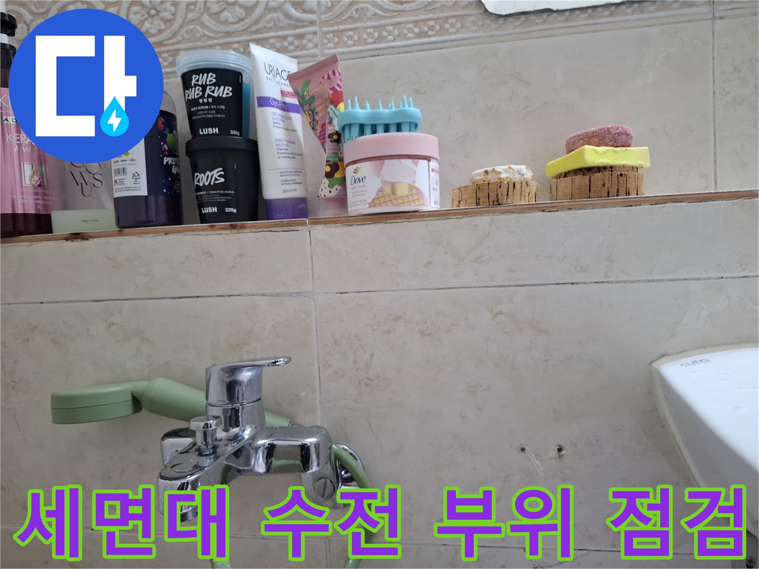 욕실 벽면에 설치된 수도꼭지와 주변 타일 마감 상태를 근접 촬영한 사진입니다.