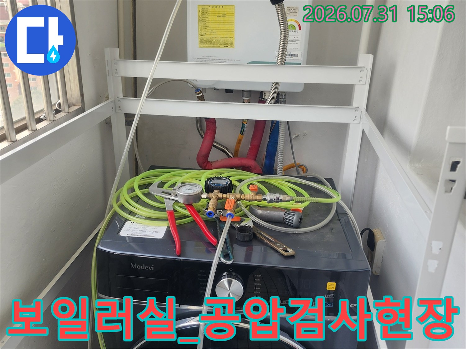 보일러 옆 배관에 공압 테스트 장비를 연결하여 누수 여부를 정밀하게 측정하는 장면