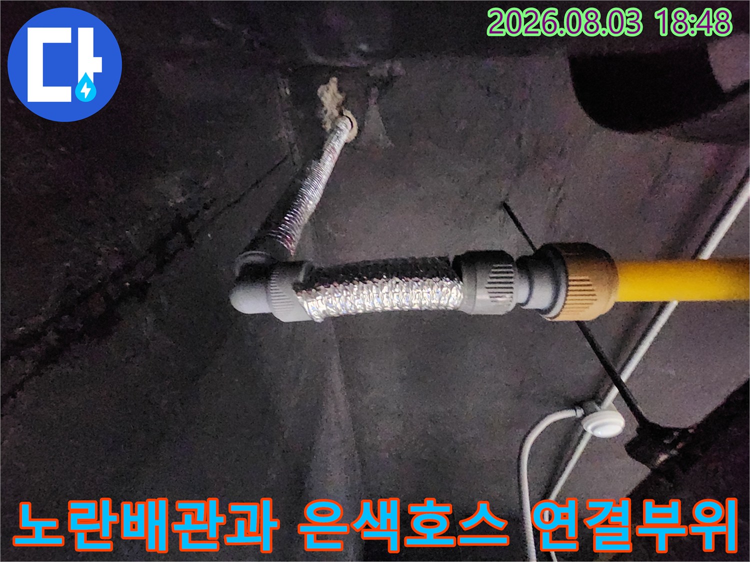 은색 호스로 감싼 배관과 노란색 직관이 연결된 지점의 상세 모습