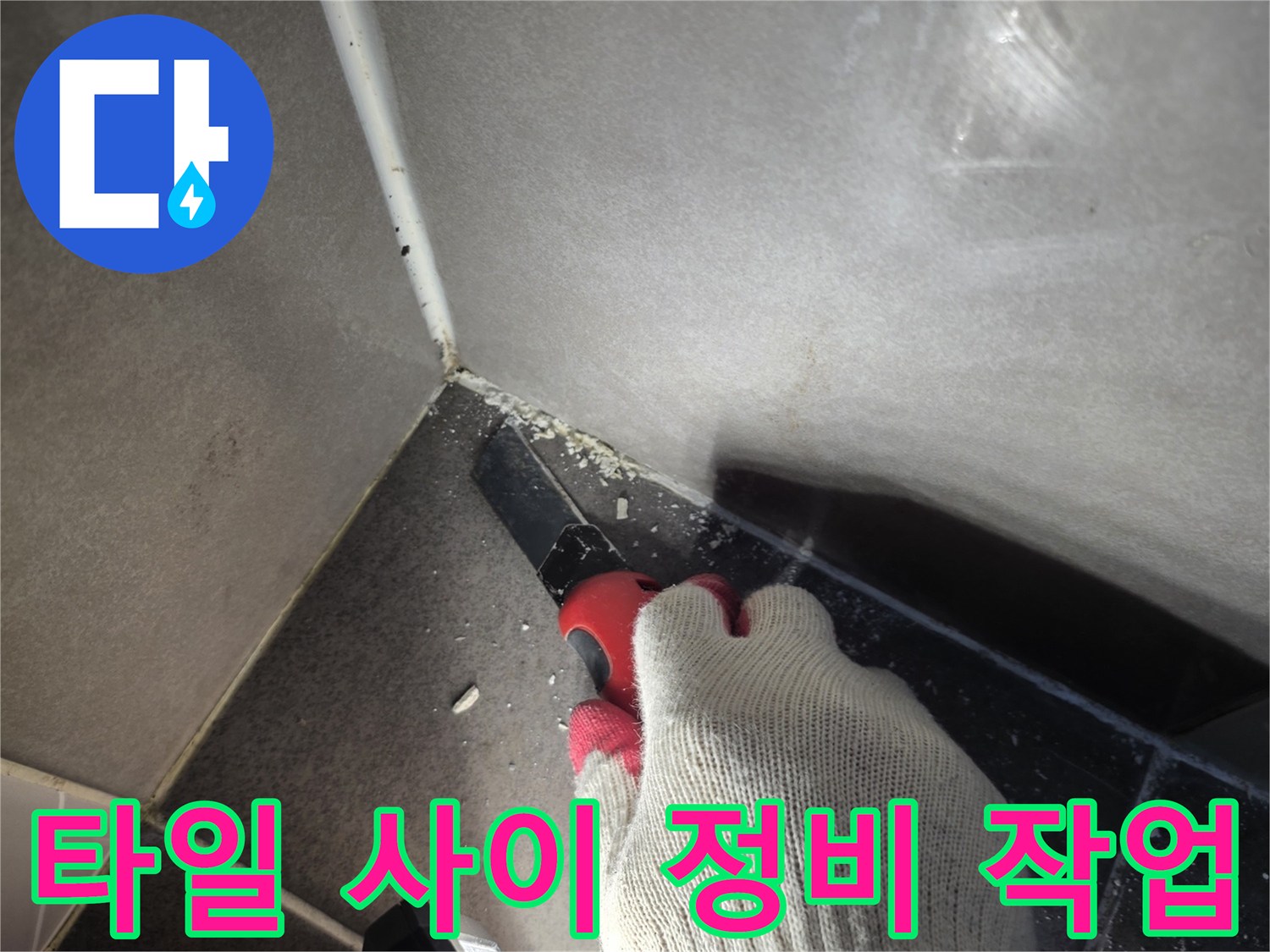 작업자가 장갑을 끼고 타일 틈새의 노후 자재를 제거하는 모습