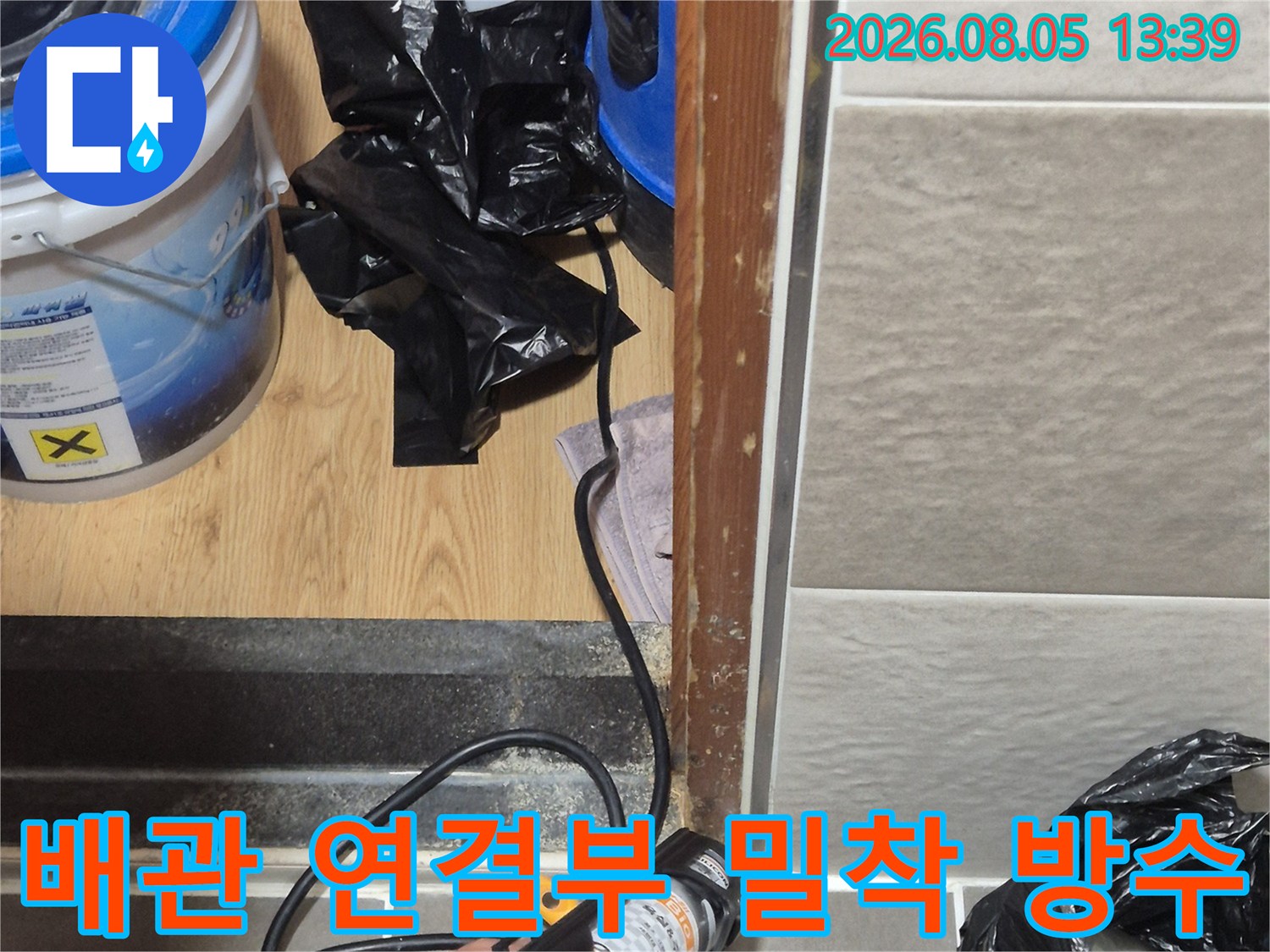 배수관과 타일 사이의 틈새를 메우며 누수를 차단하는 시공 장면